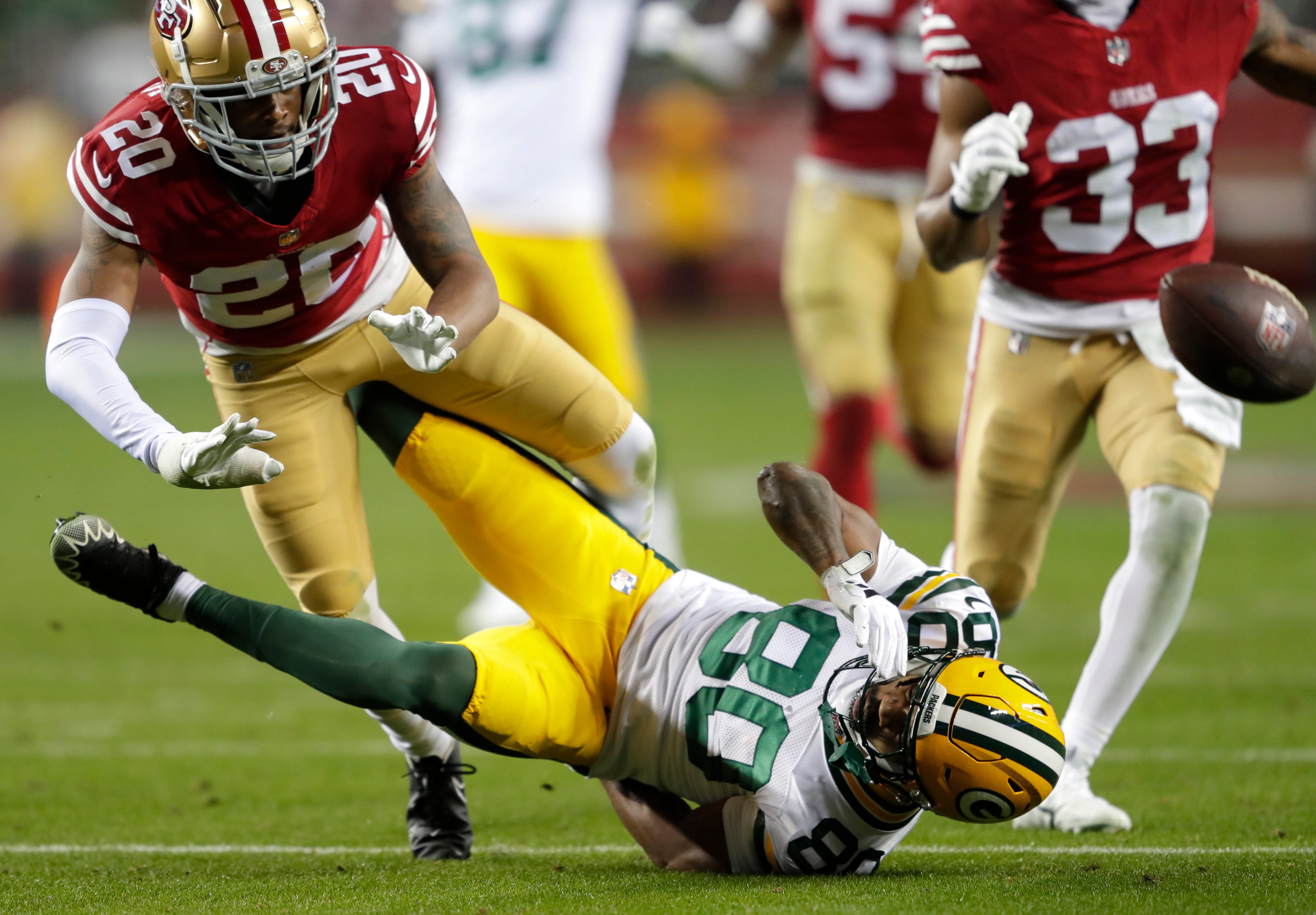 San Francisco 49ers cornerback Ambry Thomas (20) commits pass interference against Green Bay Packers wide receiver Bo Melton (80) in the thrid quarter during their NFC divisional playoff football game Saturday, January 20, 2024, at Levi's Stadium in Santa Clara, California.