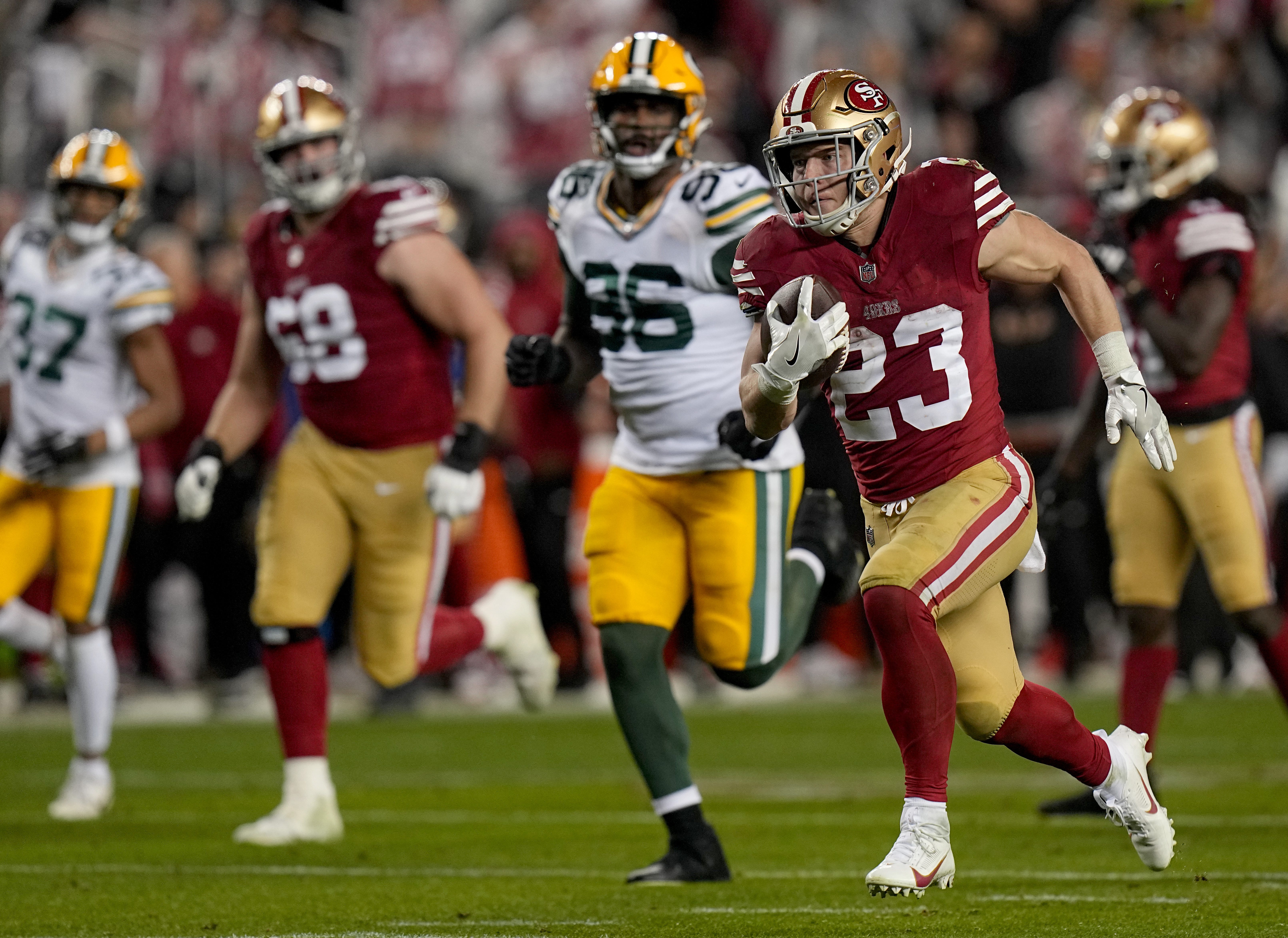 San Francisco 49ers running back Christian McCaffrey (23) scores a touchdown on a 39-yard run during the third quarter of their NFC divisional playoff game Saturday, January 20, 2024 at Levi’ Stadium in Santa Clara, California. The San Francisco 49ers beat the Green Bay Packers 24-21.