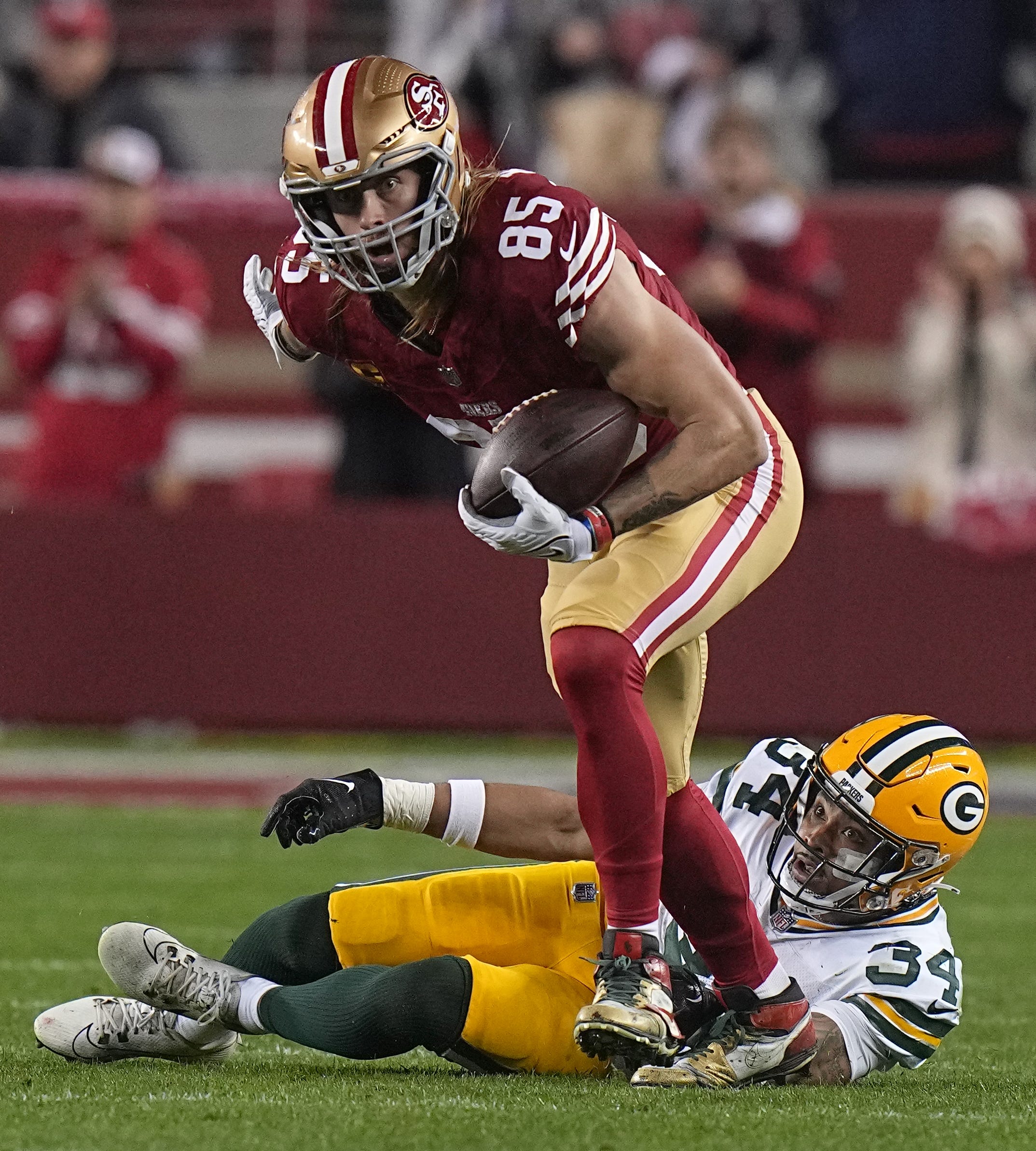 San Francisco 49ers tight end George Kittle (85) picks up 32 yard on a reception after a missed tackle by Green Bay Packers safety Jonathan Owens during the third quarter of their NFC divisional playoff game Saturday, January 20, 2024 at Levi’ Stadium in Santa Clara, California. The San Francisco 49ers beat the Green Bay Packers 24-21.