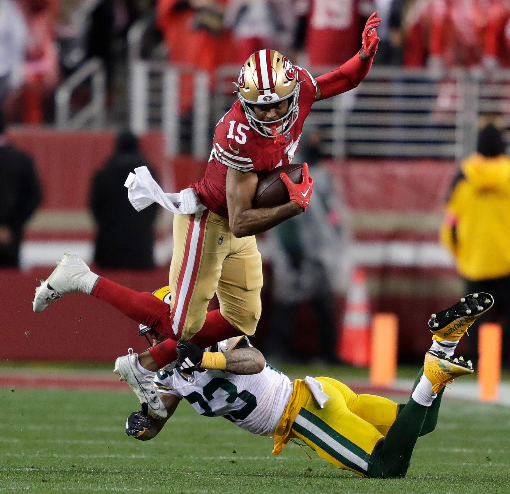 San Francisco 49ers wide receiver Jauan Jennings (15) is tackled by Green Bay Packers cornerback Jaire Alexander (23) on a fourth quarter reception during their NFC divisional playoff football game Saturday, January 20, 2024, at Levi's Stadium in Santa Clara, California.