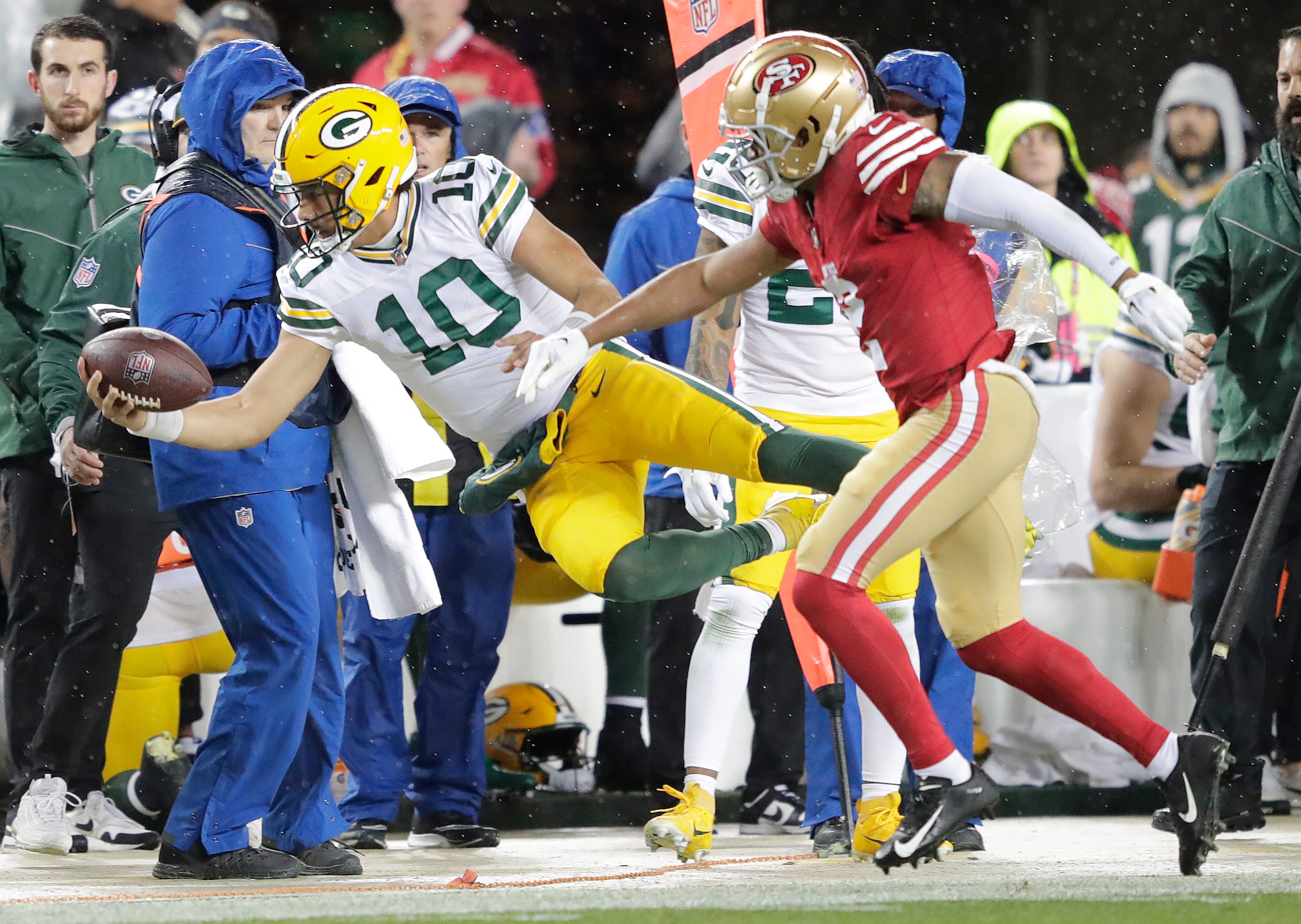 Green Bay Packers quarterback Jordan Love (10) is knocked out of bounds by San Francisco 49ers cornerback Deommodore Lenoir (2) during their NFC divisional playoff football game Saturday, January 20, 2024, at Levi's Stadium in Santa Clara, California.