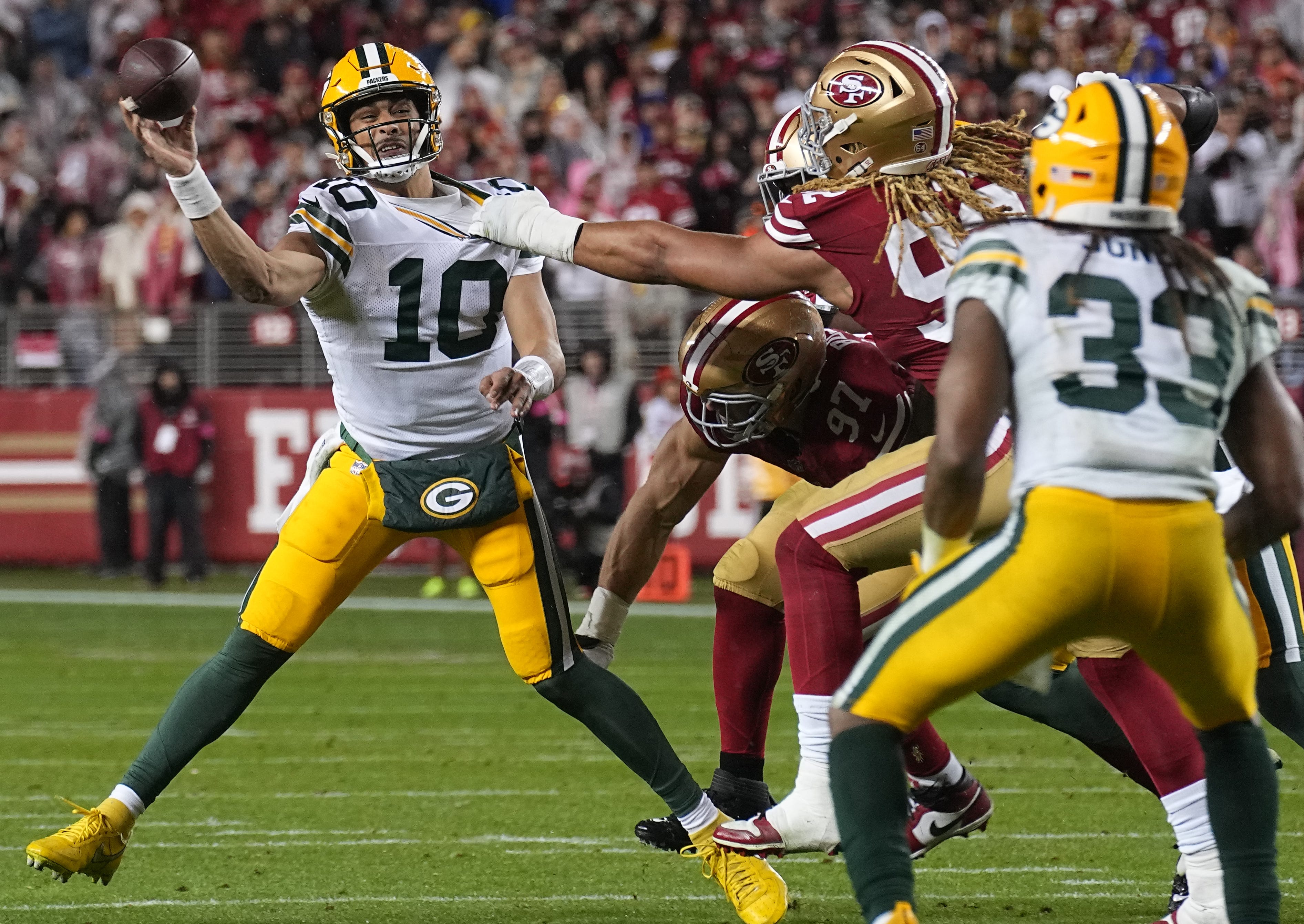 Green Bay Packers quarterback Jordan Love (10) completes a pass to running back Aaron Jones (33) during the second quarter of their NFC divisional playoff game against the San Francisco 49ers Saturday, January 20, 2024 at Levi’ Stadium in Santa Clara, California.