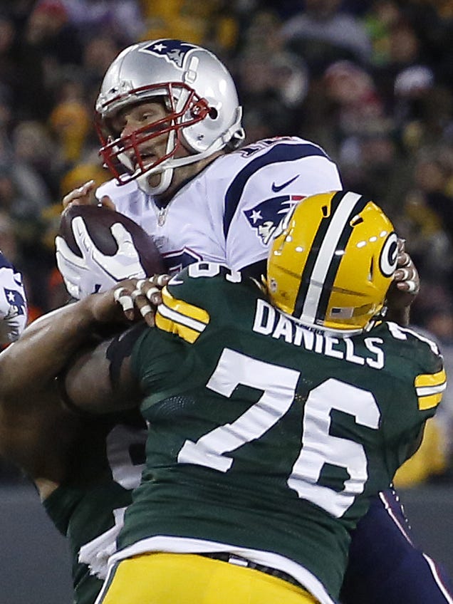Green Bay Packers defensive end Mike Daniels (76) sacks New England Patriots quarterback Tom Brady (12) in the fourth quarter on Nov. 30, 2014, at Lambeau Field.