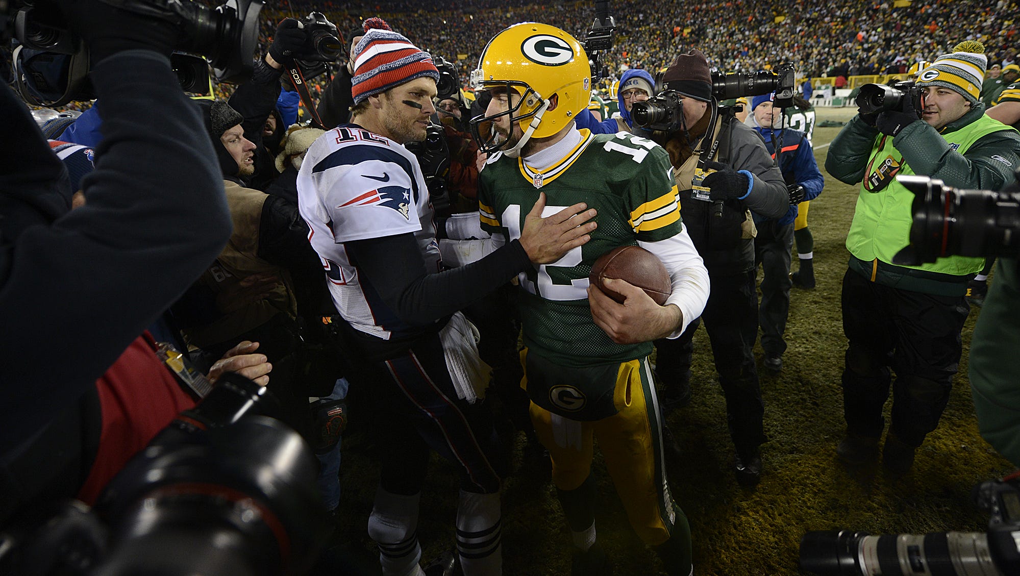 Green Bay Packers quarterback Aaron Rodgers and New England Patriots quarterback Tom Brady exchange words after their game on Nov. 30, 2014, at Lambeau Field.