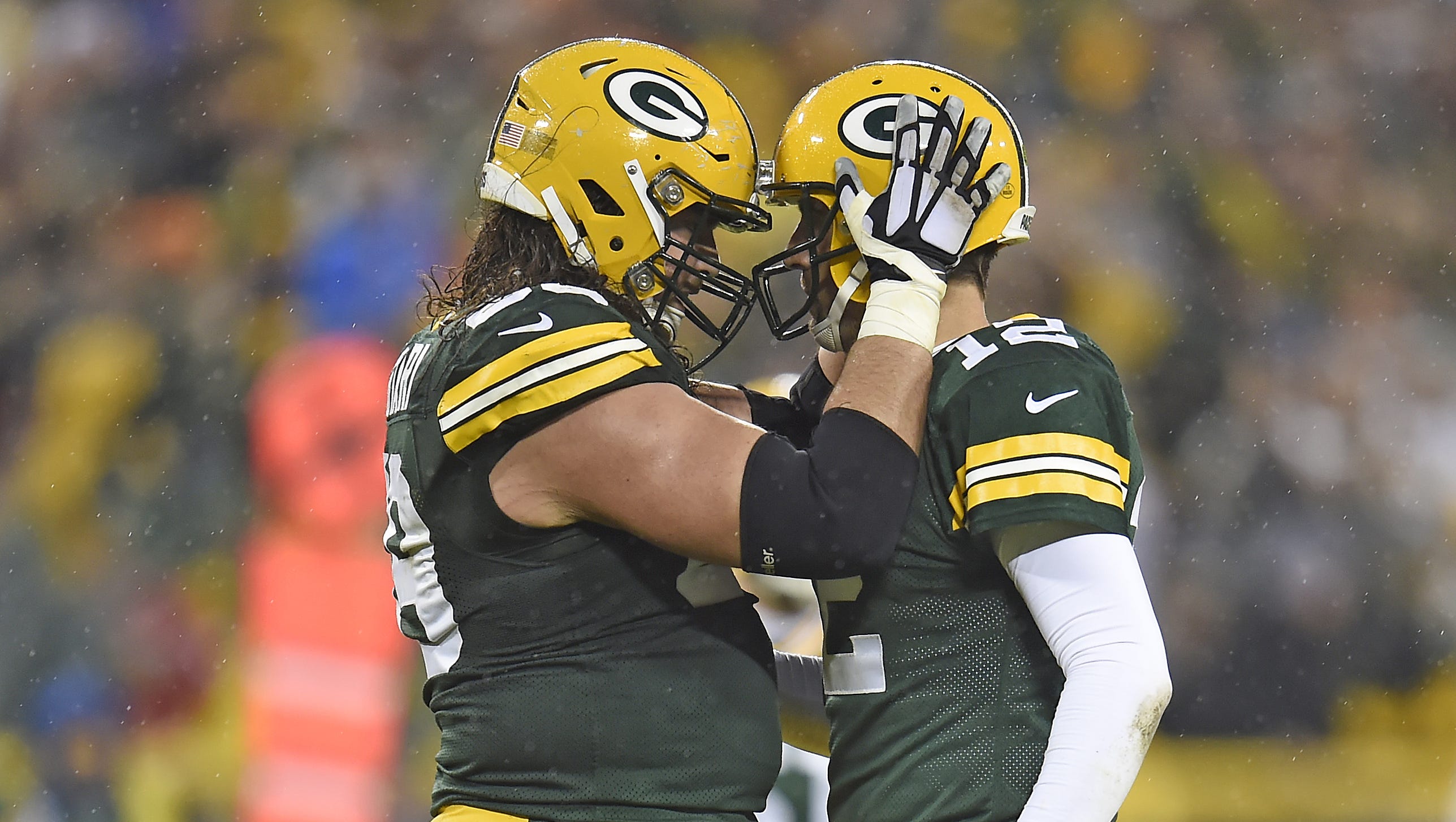 Green Bay Packers quarterback Aaron Rodgers (12) celebrates a touchdown with left tackle David Bakhtiari (69) against the Dallas Cowboys on Dec. 13, 2015, at Lambeau Field.