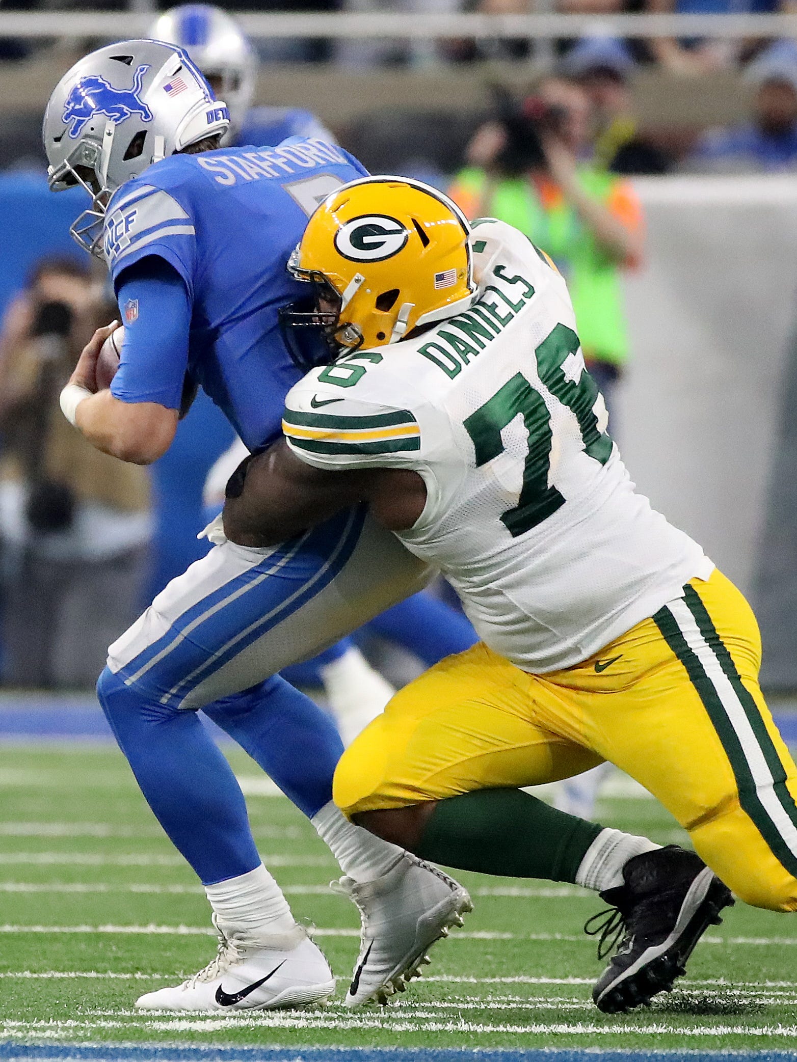 Green Bay Packers defensive end Mike Daniels (76) sacks Detroit Lions quarterback Matthew Stafford (9) on  Dec. 31, 2017, at Ford Field in Detroit.
