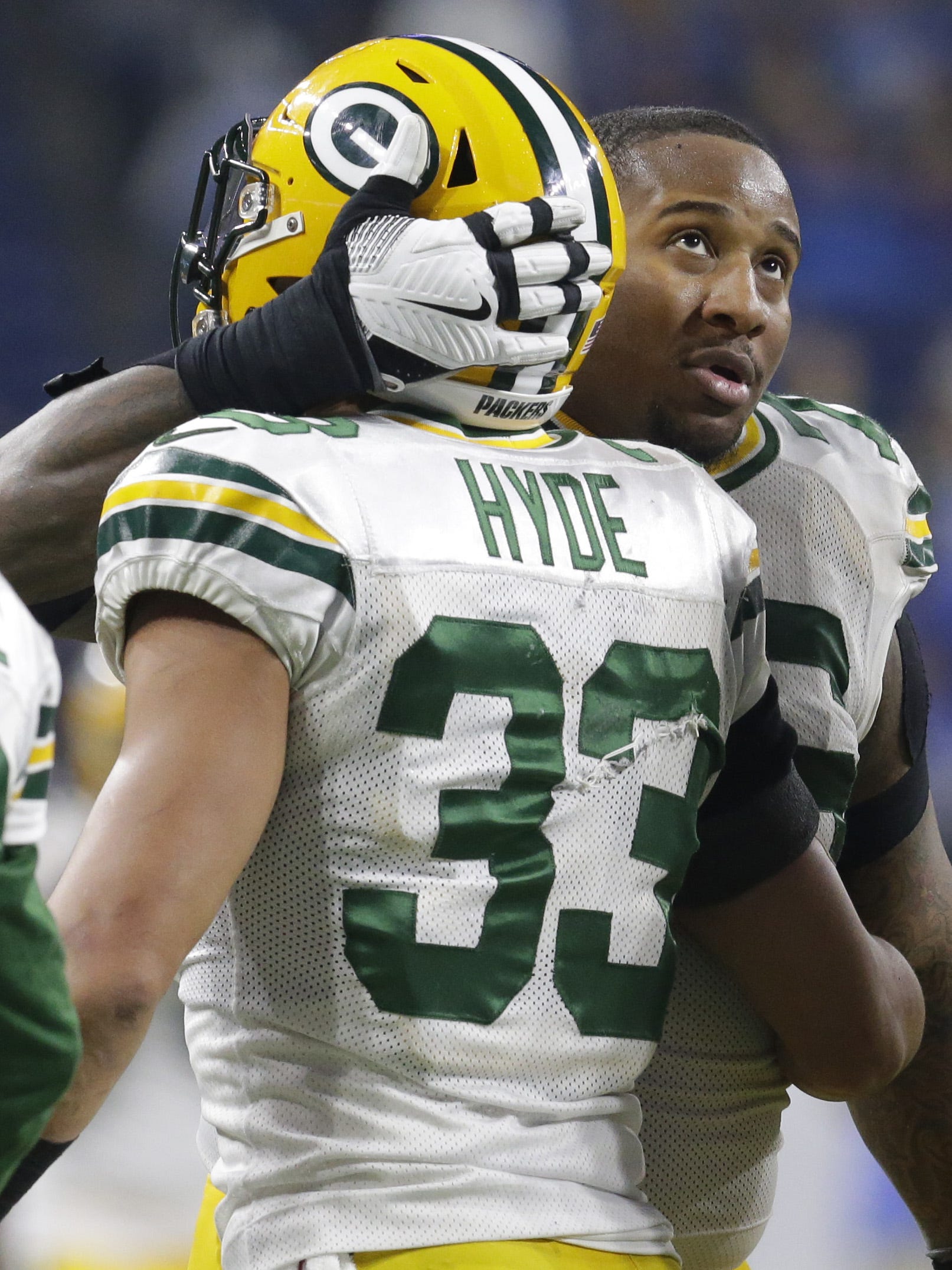 Green Bay Packers defensive end Mike Daniels (76) embraces strong safety Micah Hyde (33) after Hyde made an interception in the waning moments of the fourth quarter of their game on Jan. 1, 2017, at Ford Field in Detroit.
