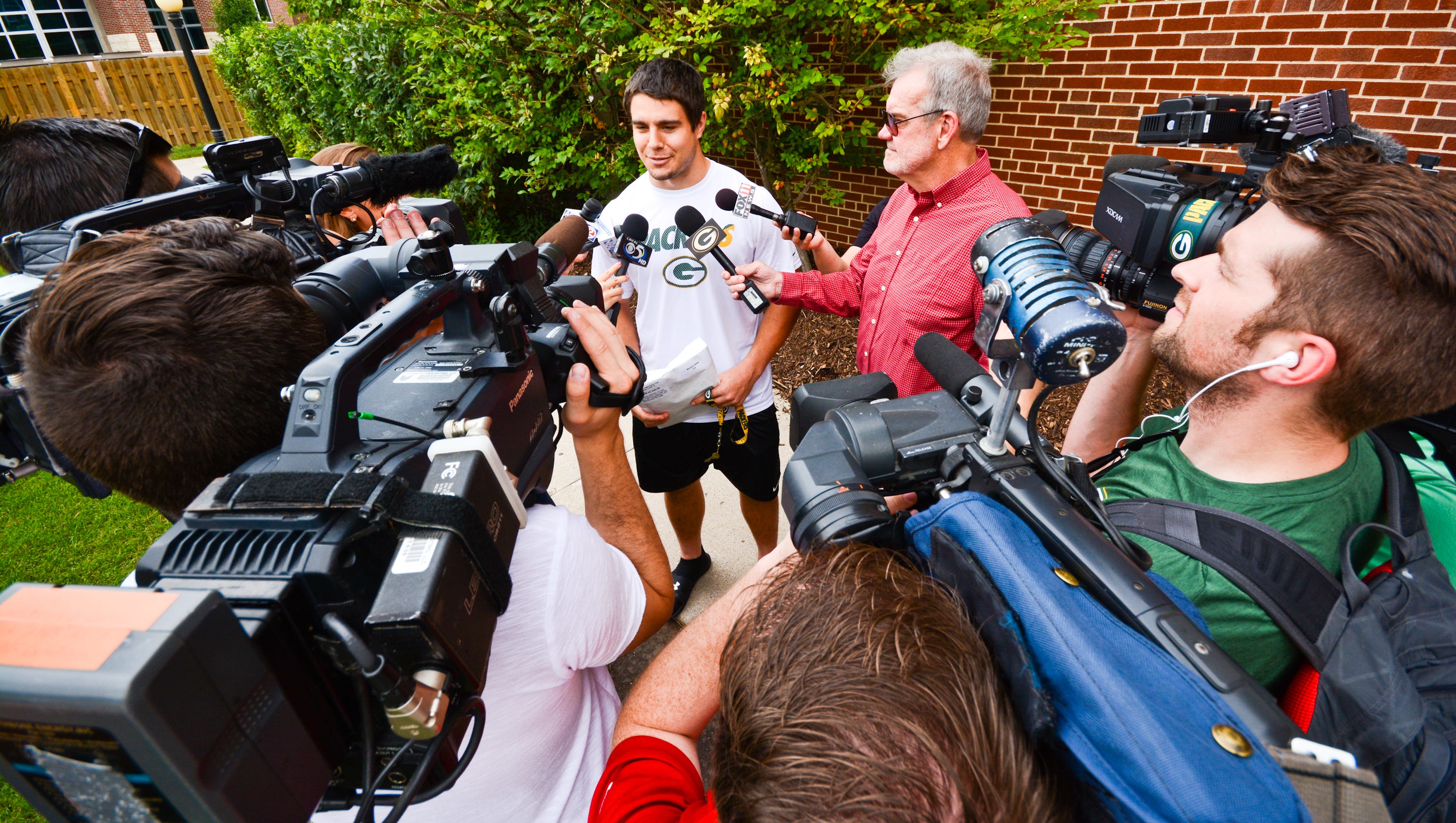 Green Bay Packers rookie Blake Martinez speaks with reporters outside Victor McCormick Hall at St. Norbert College, where he, along with other team members, stay during their summer training camp.
