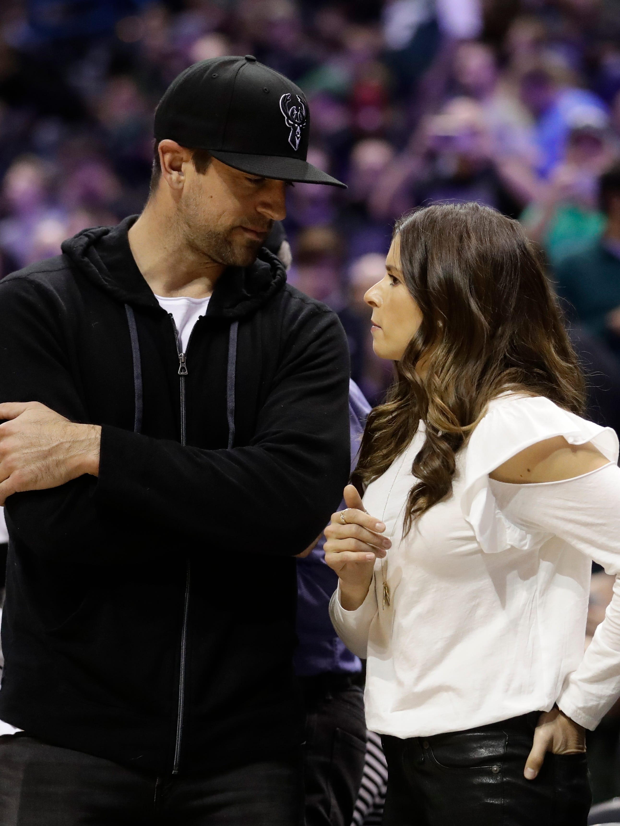 Green Bay Packers' Aaron Rodgers talks with Danica Patrick at Game 3 of the playoff series between the Bucks and the Celtics.