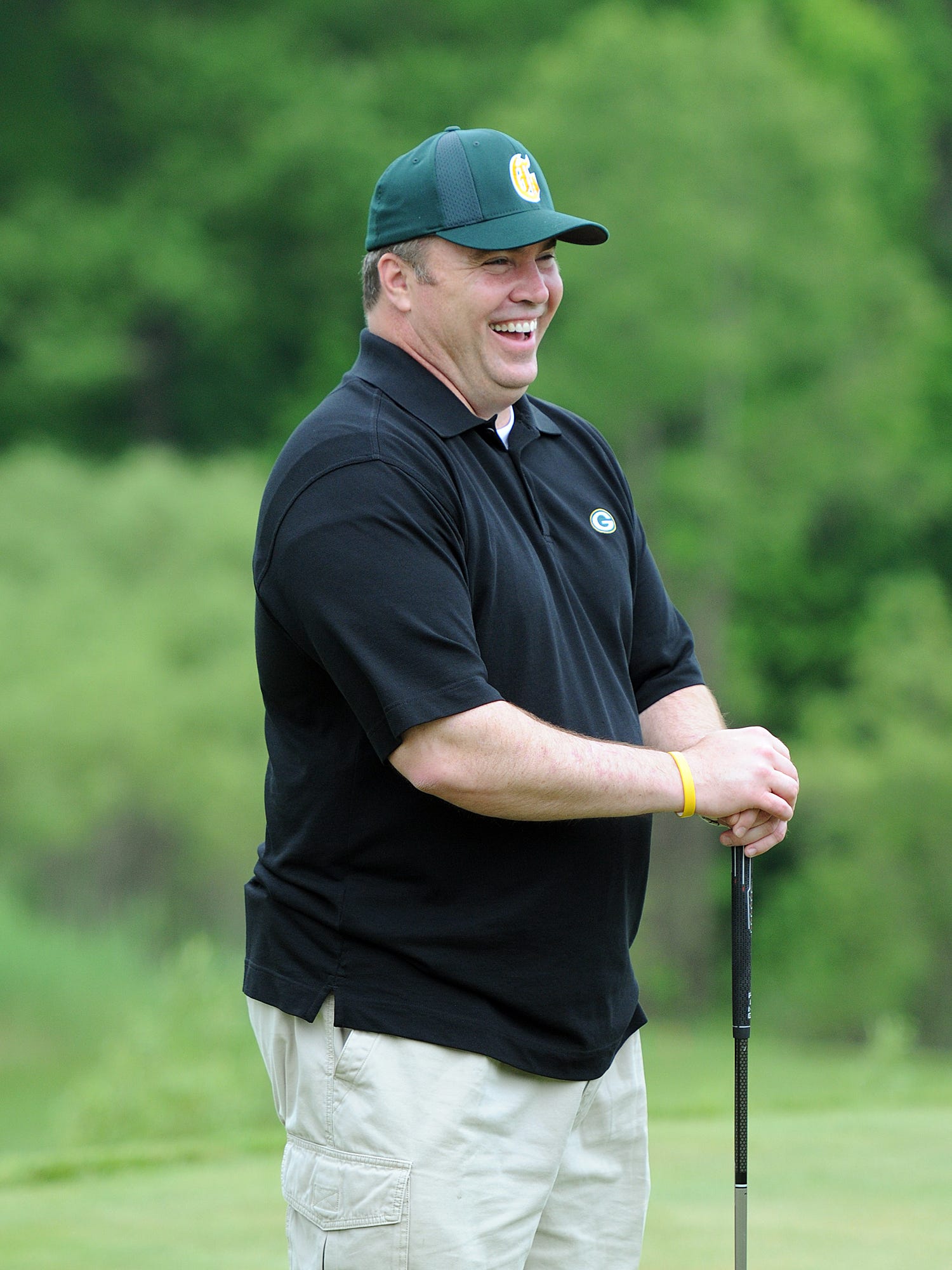 Green Bay Packers coach Mike McCarthy reacts while waiting to pose for photographs with golfers on the first tee box at the Mike McCarthy Cystic Fibrosis Celebrity Golf Tournament on June 6, 2011, at the Green Bay Country Club.