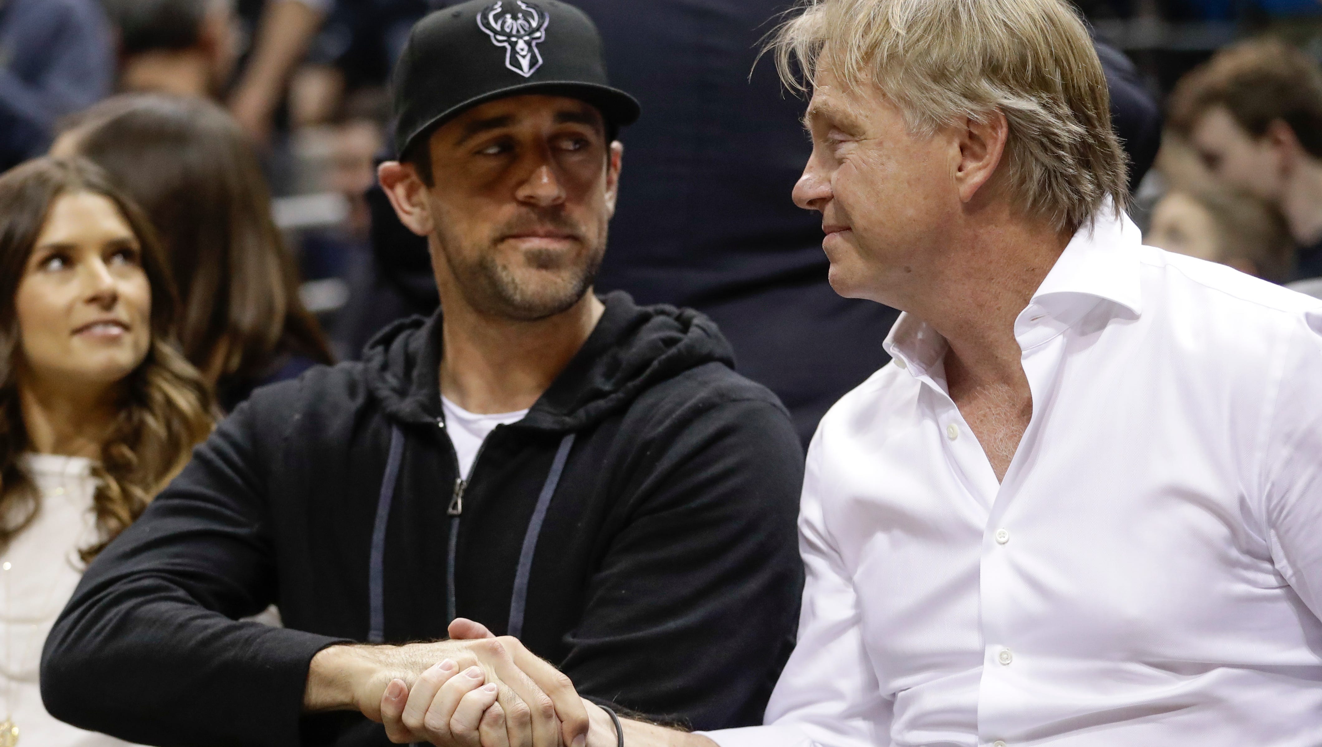 Milwaukee Bucks owner Wes Edens and Green Bay Packers QB Aaron Rodgers shake hands during the Bucks- Celtics game Friday. Rodgers joined the Bucks' ownership group.
