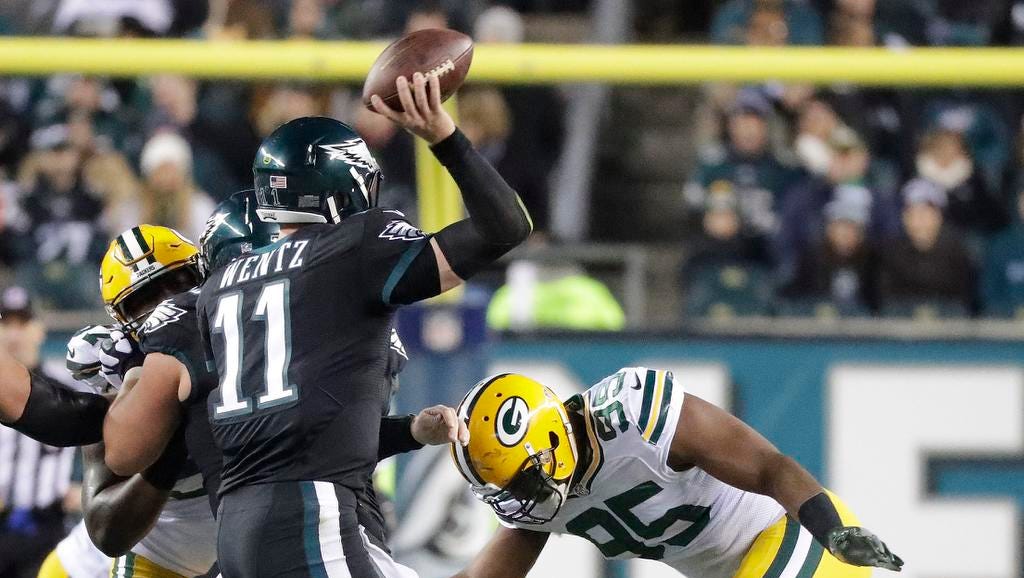 Green Bay Packers defensive end Datone Jones (95) closes in on quarterback Carson Wentz (11) against the Philadelphia Eagles at Lincoln Financial Field.