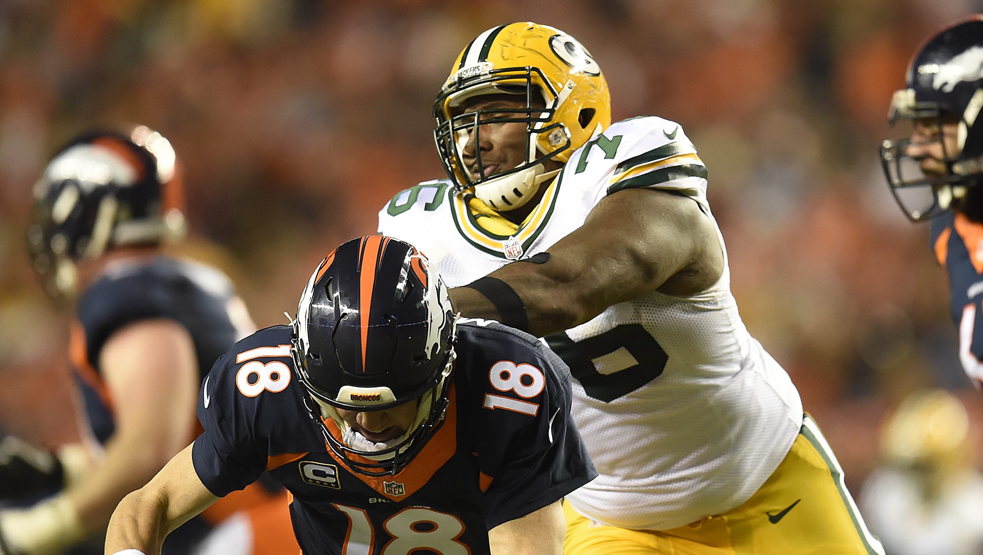 Green Bay Packers defensive tackle Mike Daniels (76) hits Denver Broncos quarterback Peyton Manning (18) on Nov. 1, 2015, at Sports Authority Field in Denver.