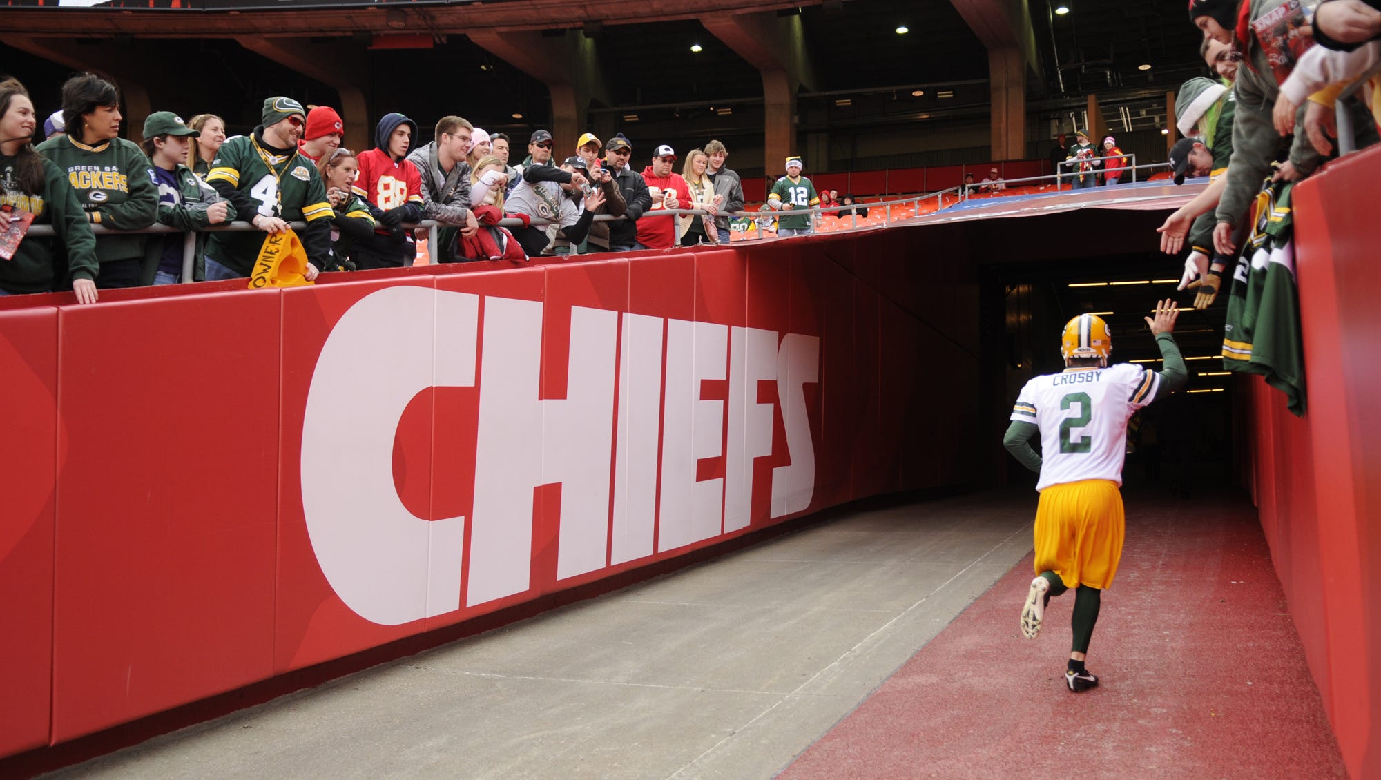 Green Bay Packers kicker Mason Crosby (2) gives high-fives to fans as he runs into the tunnel before the game against the Kansas City Chiefs on Dec. 18, 2011, at Arrowhead Stadium in Kansas City, Mo.