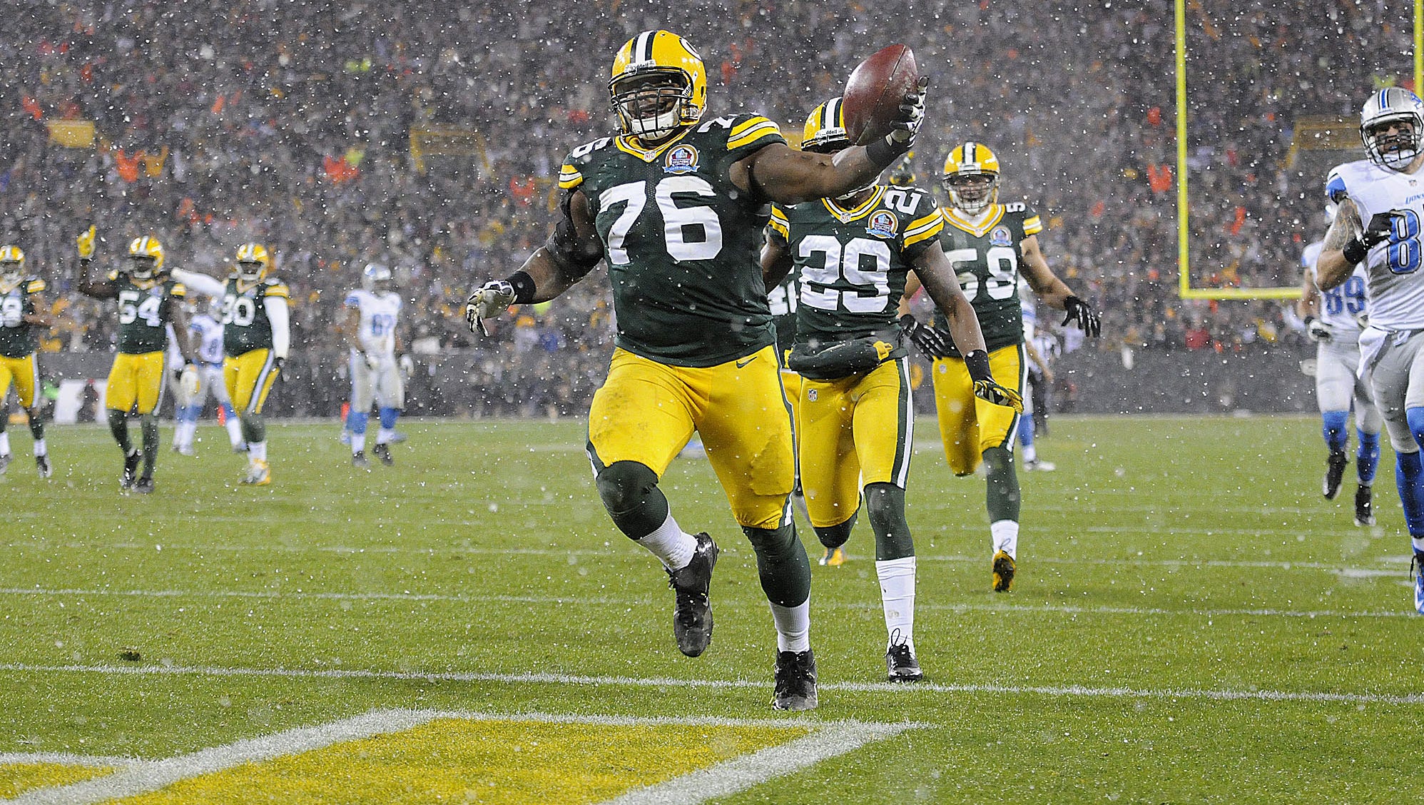 Green Bay Packers defensive end Mike Daniels (76) runs into the end zone after recovering a fumble and returning it for a touchdown in the second quarter of a 2012 game against the Detroit Lions at Lambeau Field.