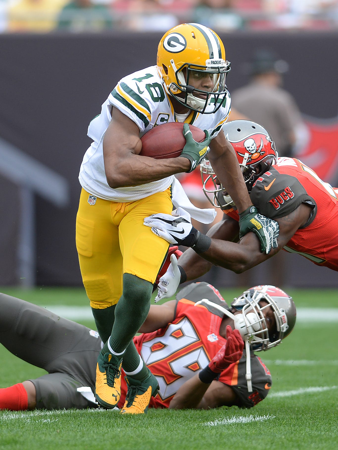 Green Bay Packers receiver Randall Cobb (18) breaks a tackle against the Tampa Bay Buccaneers from Raymond James Stadium.