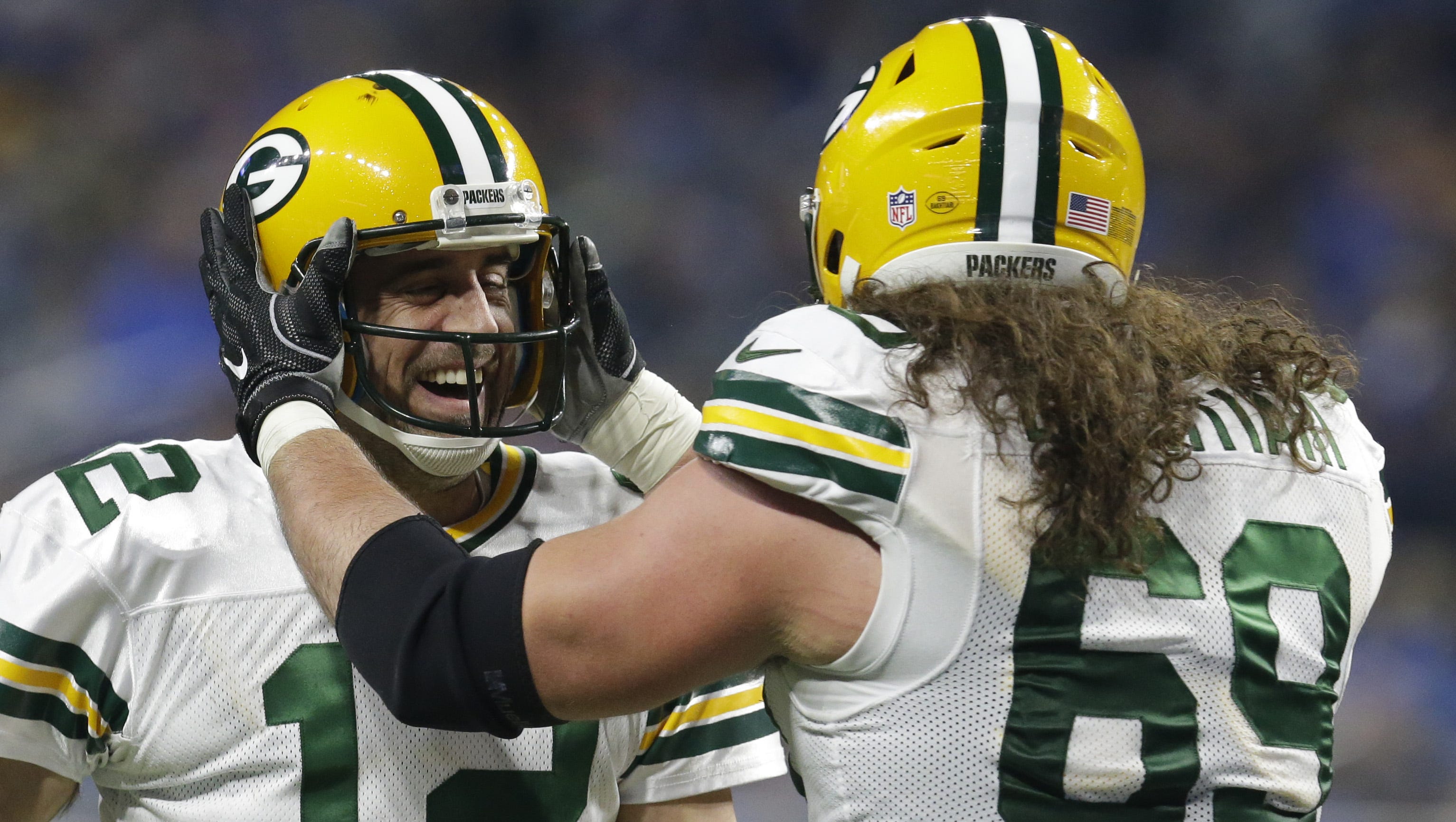 Green Bay Packers quarterback Aaron Rodgers (12) and left tackle David Bakhtiari (69) celebrate fullback Aaron Ripkowski's (22) touchdown run during the second quarter against the Detroit Lions on Jan. 1, 2017 at Ford Field in Detroit.