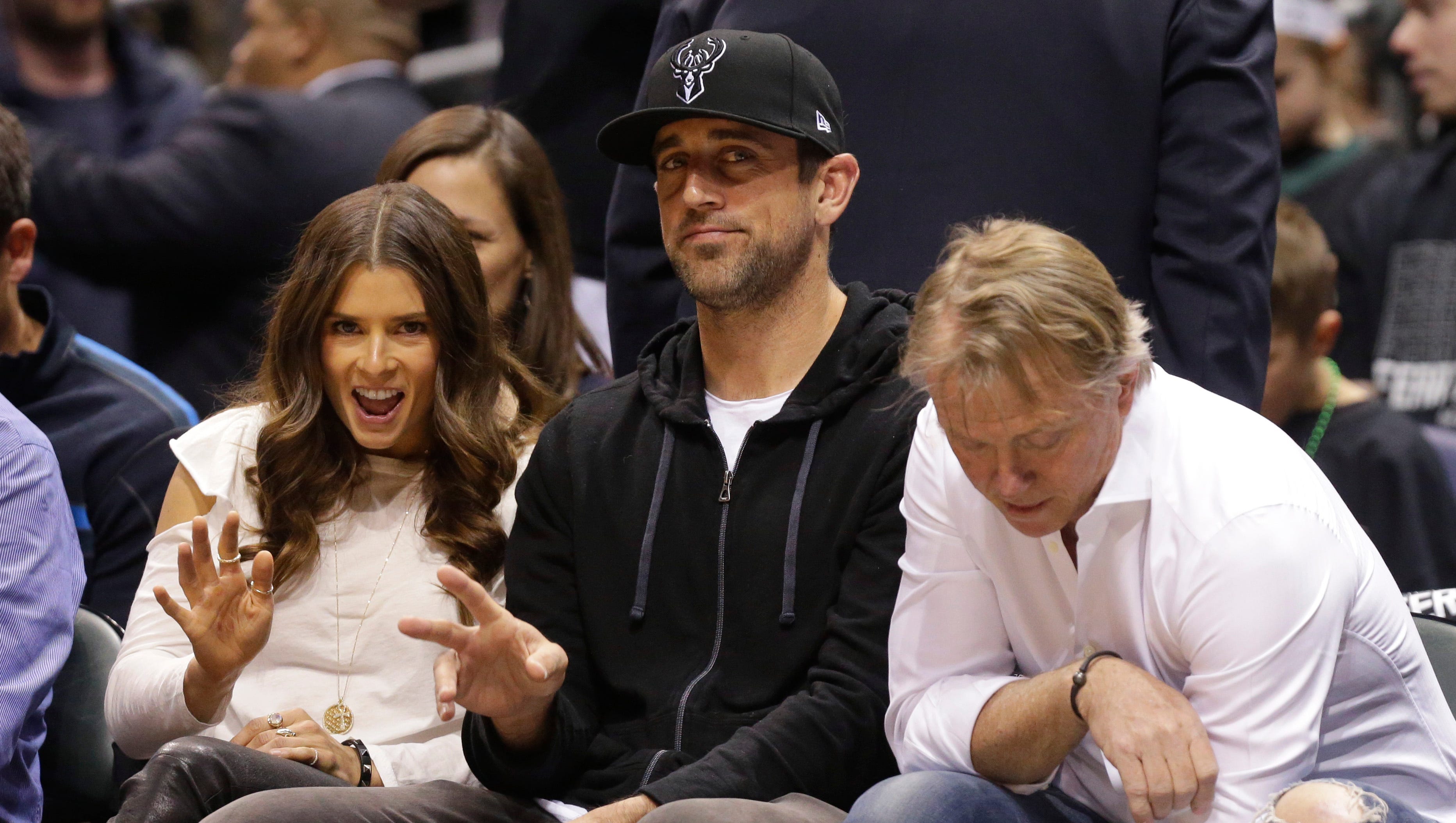 Danica Patrick and Aaron Rodgers look on during Game 3 of the first-round playoff series between the Bucks and Celtics at the BMO Harris Bradley Center in Milwaukee on Friday night. Next to Rodgers is Bucks co-owner Wes Edens.