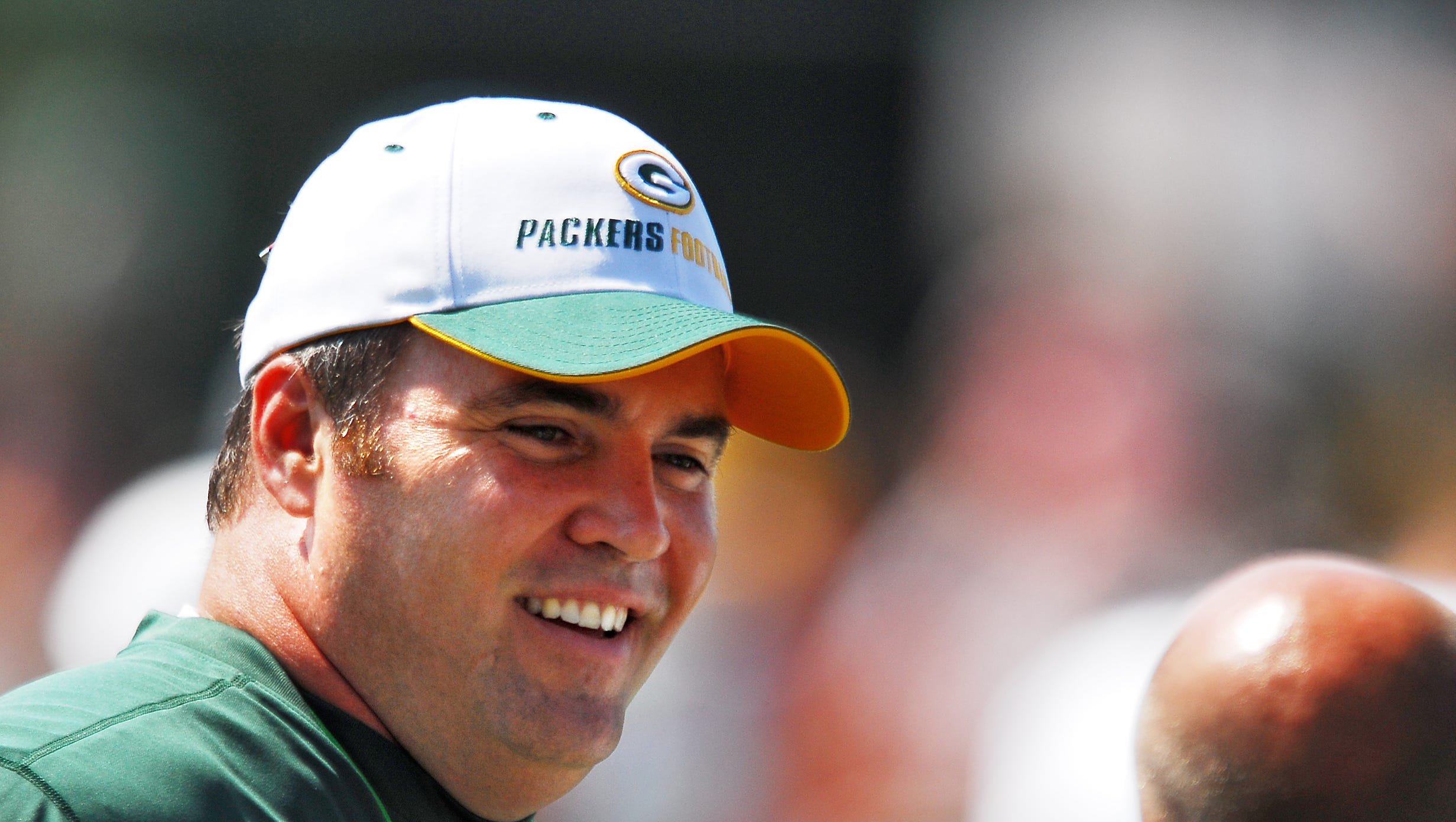 Green Bay Packers coach Mike McCarthy talks with a staff member during training camp practice on Aug. 4, 2006, at Clarke Hinkle Field in Ashwaubenon.