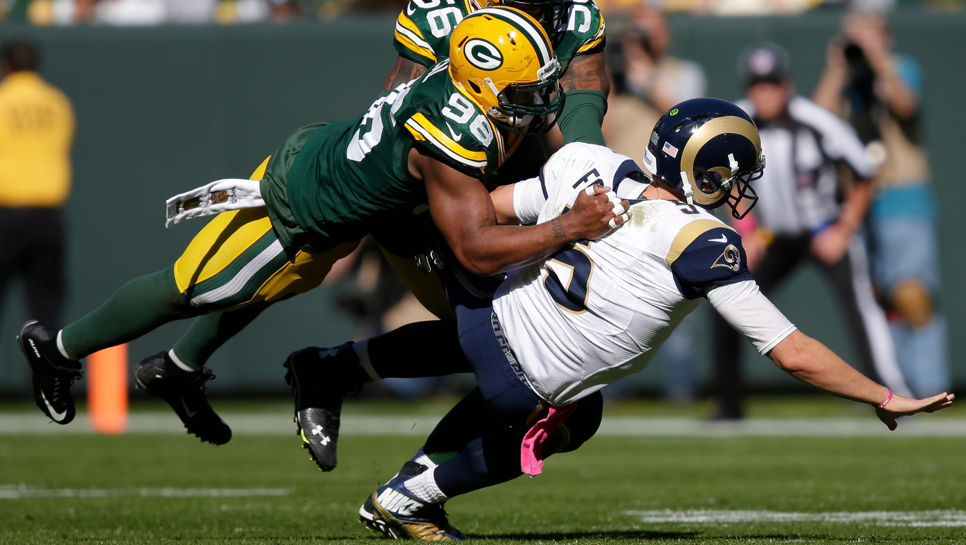 Green Bay Packers linebacker Mike Neal pressures St. Louis Rams quarterback Nick Foles.
