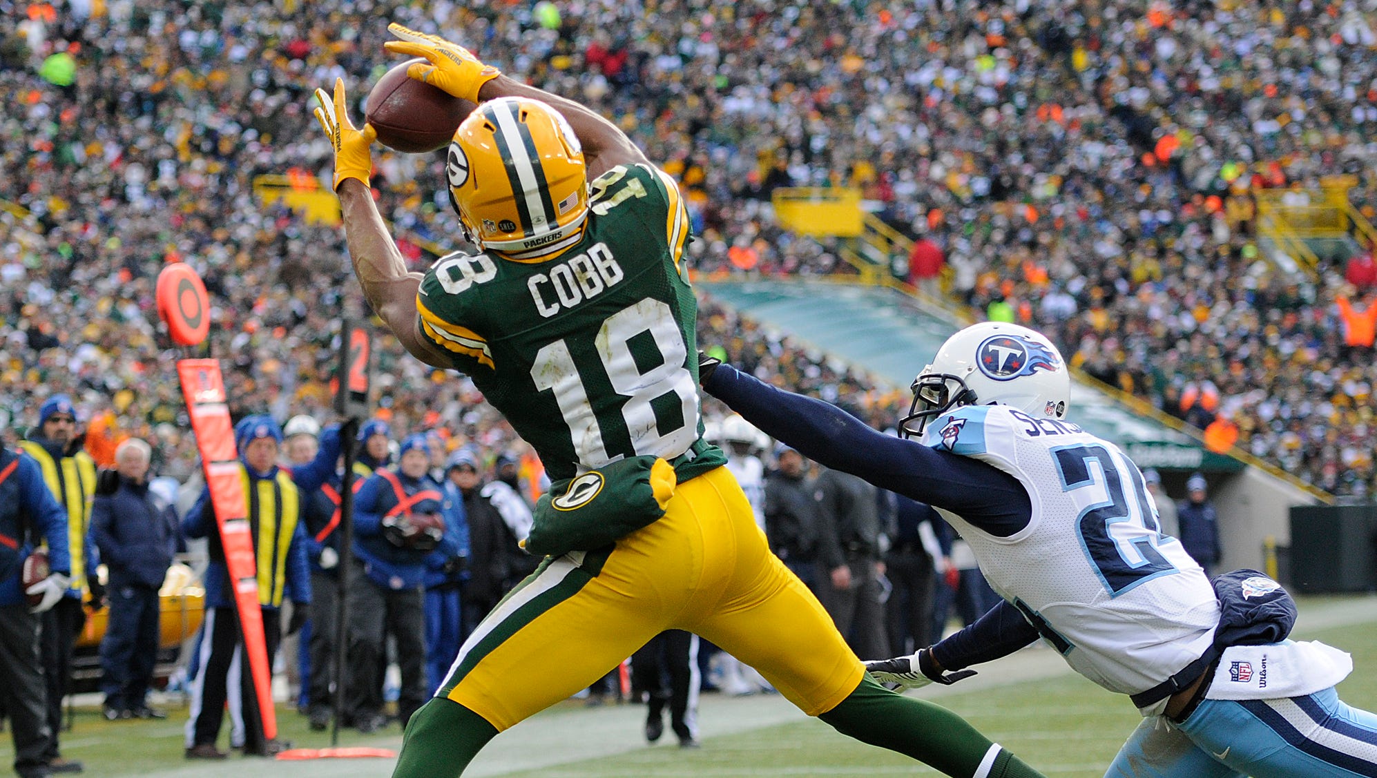 Green Bay Packers receiver Randall Cobb (18) makes a touchdown catch past Tennessee Titans cornerback Coty Sensabaugh (24) in a 2012 game at Lambeau Field.