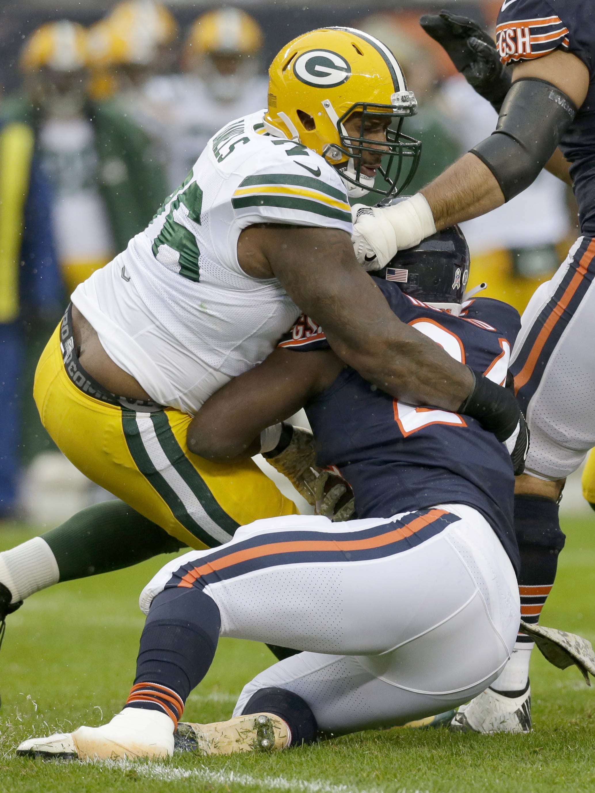 Green Bay Packers defensive end Mike Daniels (76) tackles Chicago Bears running back Jordan Howard (24) during the first quarter on Nov. 12, 2017, at Soldier Field in Chicago.