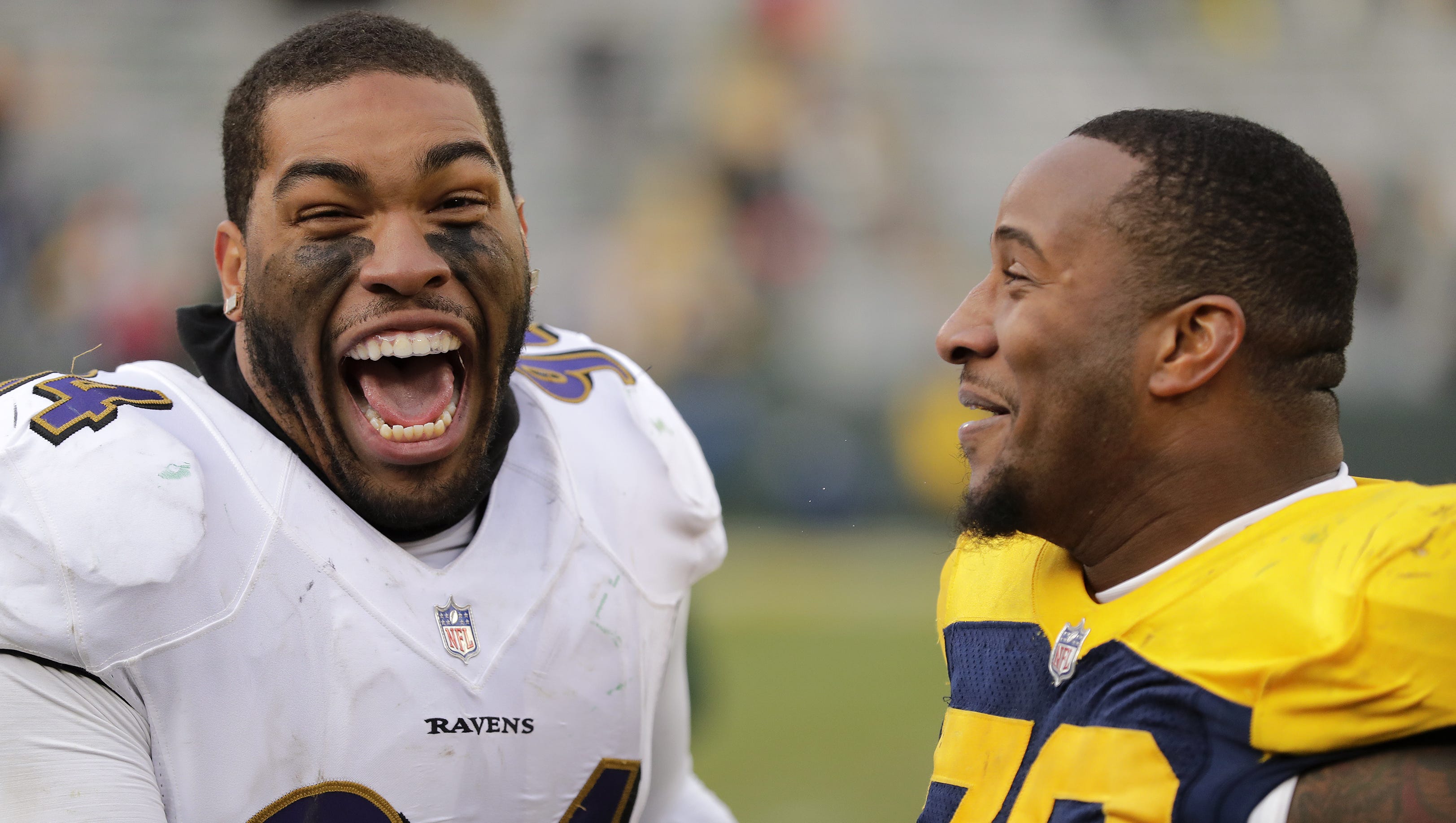 Baltimore Ravens defensive end Carl Davis (94) and Green Bay Packers defensive end Mike Daniels (76) laugh together after their game on Nov. 19, 2017, at Lambeau Field.