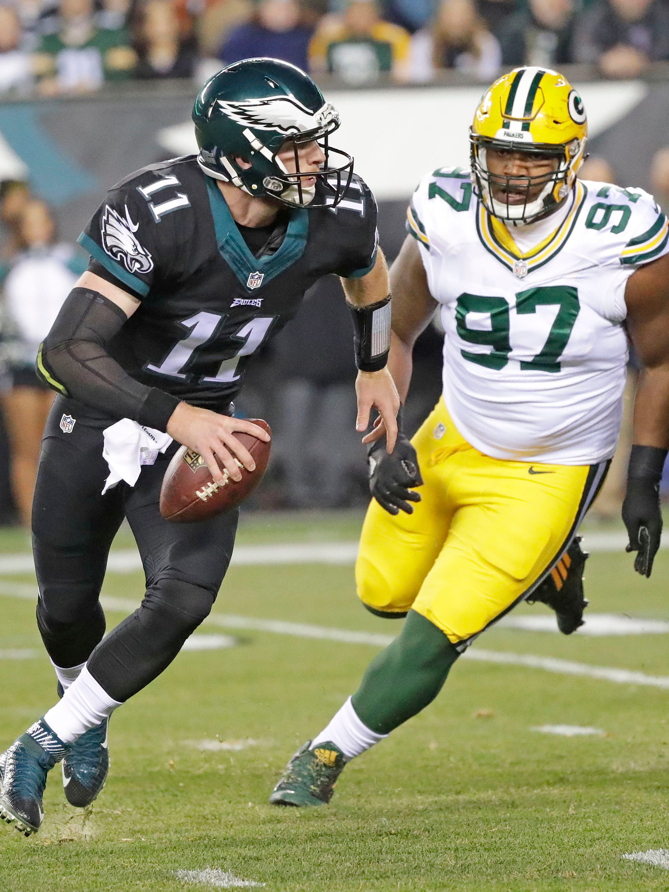 Green Bay Packers nose tackle Kenny Clark (97) chases quarterback Carson Wentz (11) against the Philadelphia Eagles at Lincoln Financial Field in Philadelphia, PA, November 28, 2016.