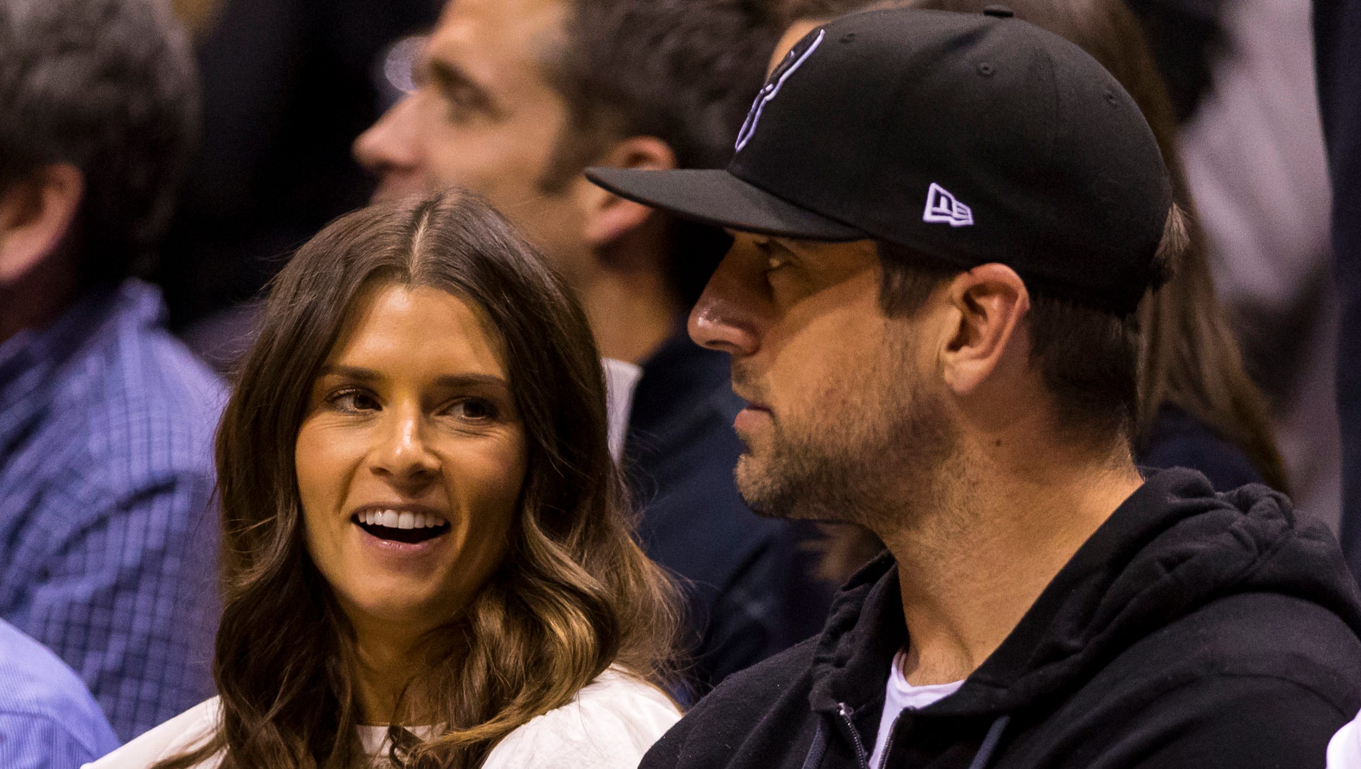 Danica Patrick and Aaron Rodgers look on during the first quarter of Game 3 between the Boston Celtics and Milwaukee Bucks.