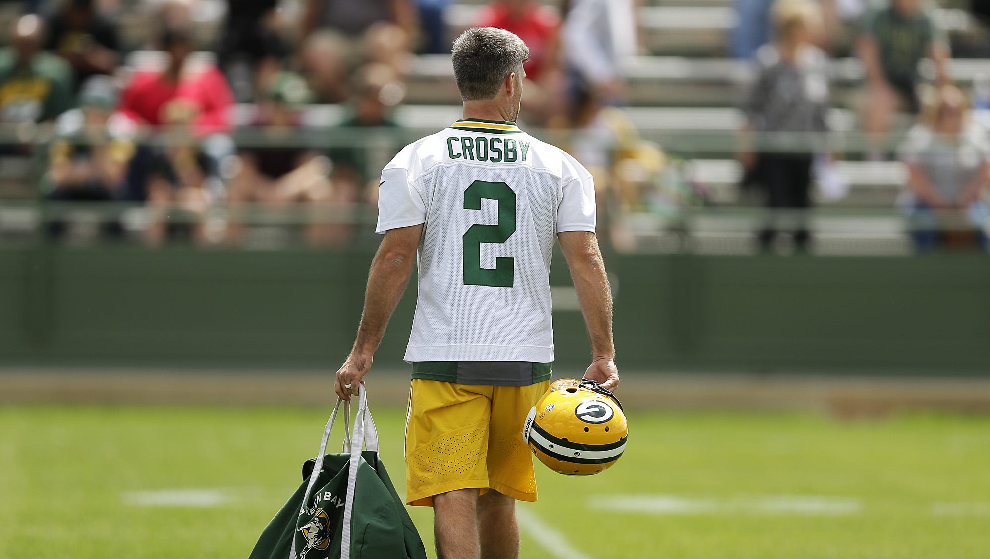 Green Bay Packers kicker Mason Crosby walks onto the practice field during OTAs at Ray Nitschke Field on June 2, 2016.