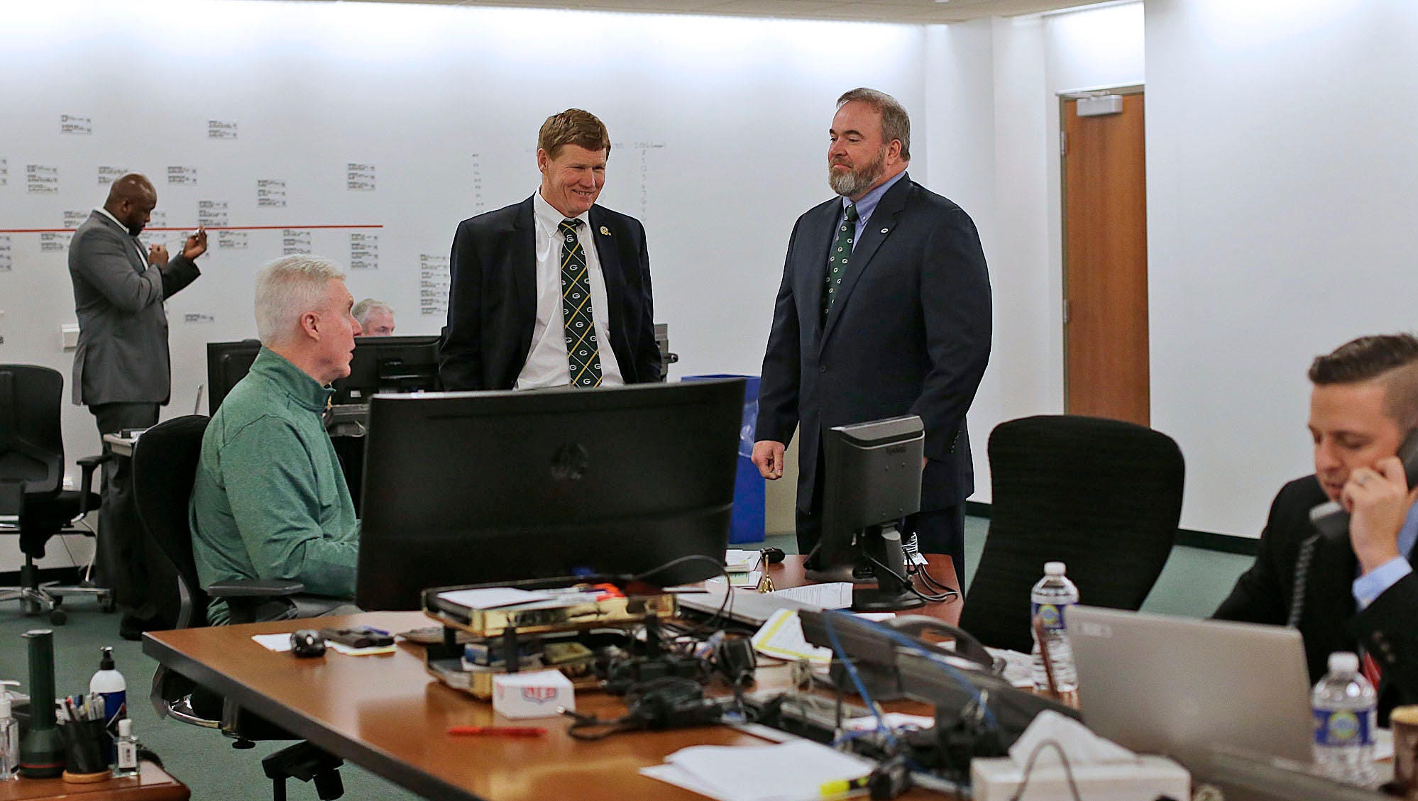 From left, Green Bay Packers general manager Ted Thompson, president Mark Murphy and coach Mike McCarthy visit with each other during the NFL draft at Lambeau Field.