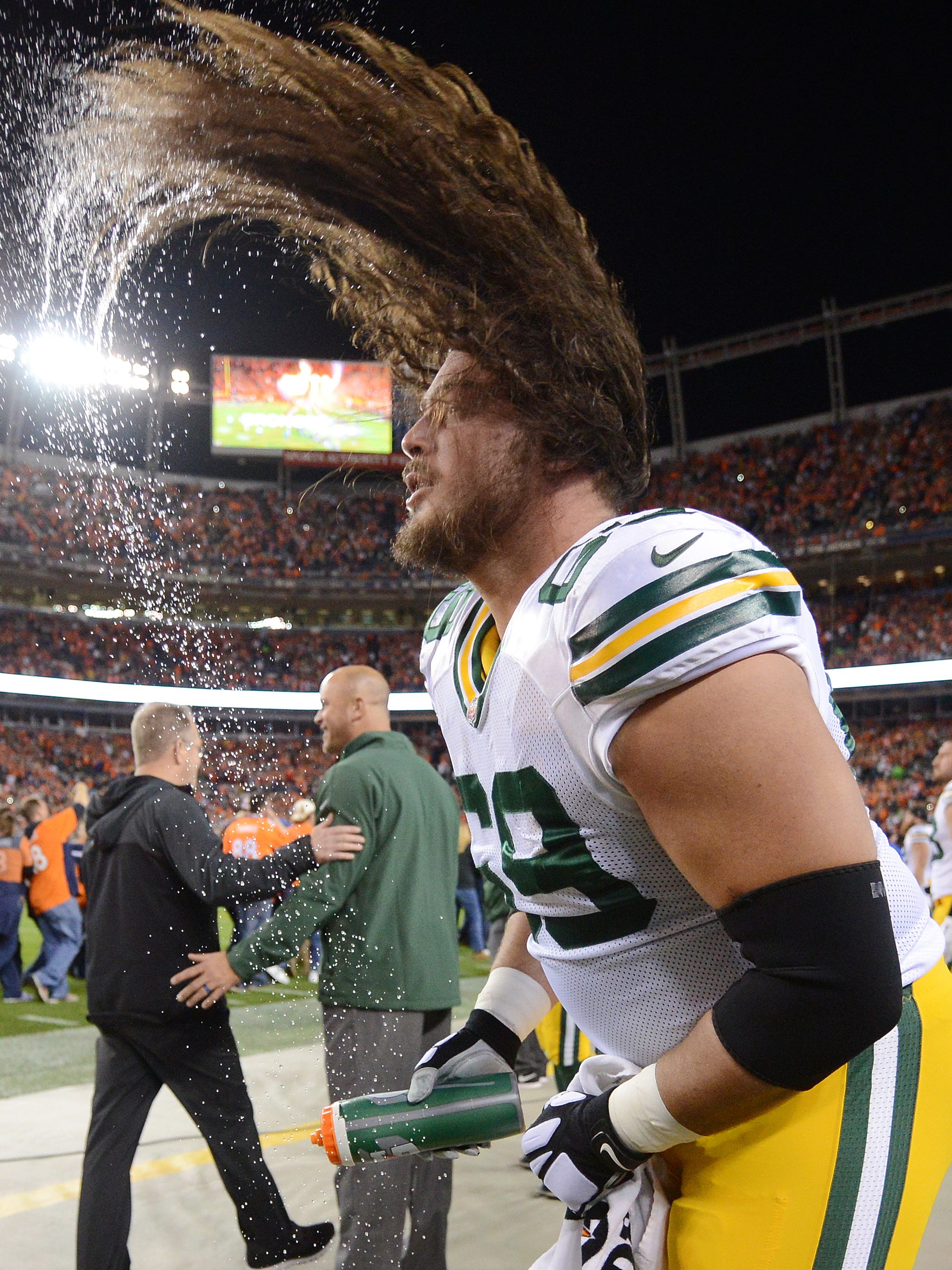 Green Bay Packers tackle David Bakhtiari (69) does a wet hair flip before the game against the Denver Broncos on Nov. 1, 2015, at Sports Authority Field in Denver.