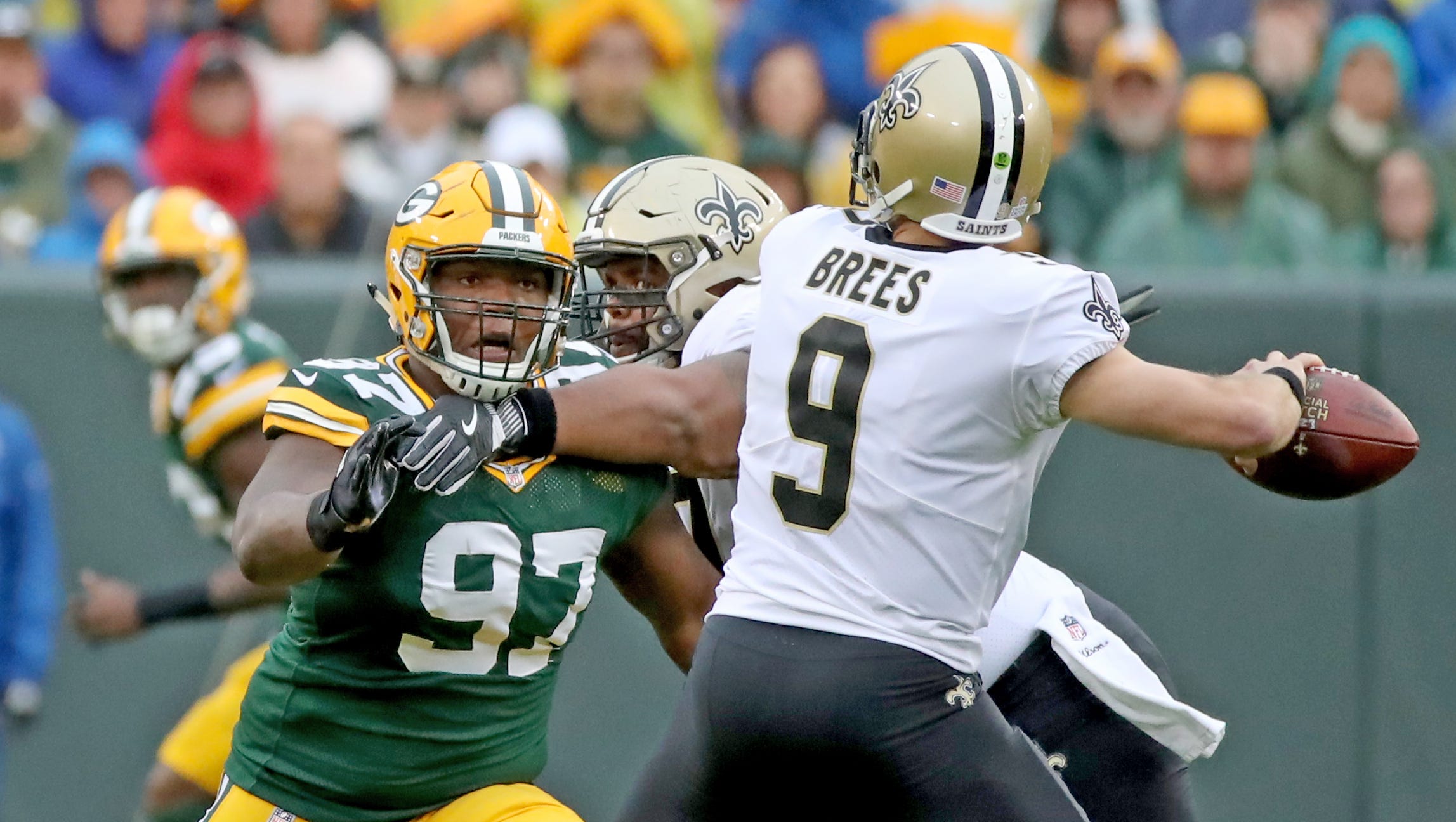 Green Bay Packers nose tackle Kenny Clark (97) rushes in on quarterback Drew Brees (9) against the New Orleans Saints Sunday, October 22, 2017 at Lambeau Field in Green Bay, Wis.