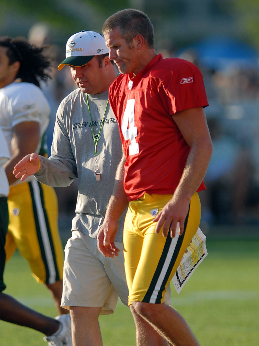 Green Bay Packers coach Mike McCarthy and quarterback Brett Favre talk during training camp practice on Aug. 3, 2006, at Clarke Hinkle Field.