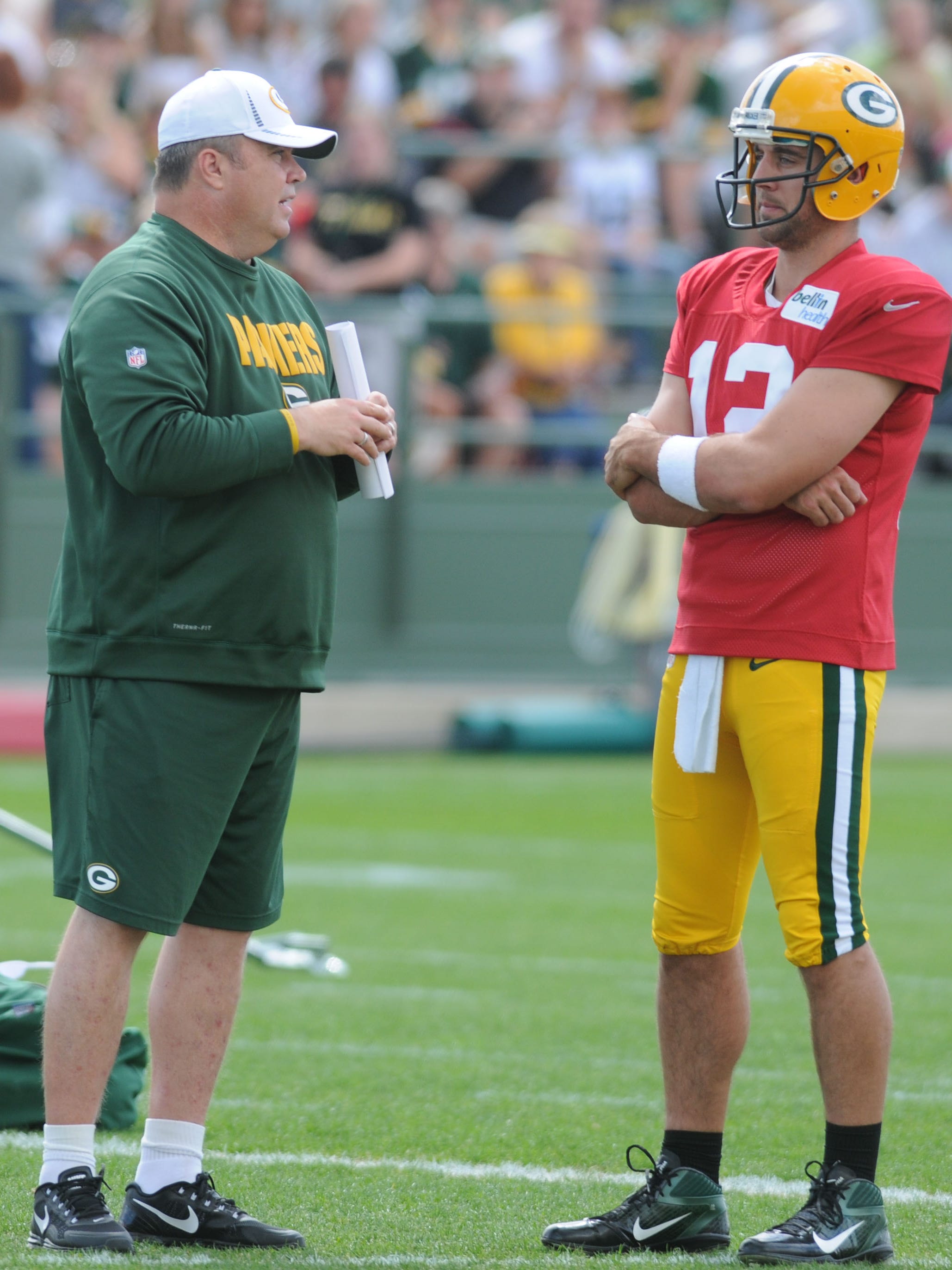 Green Bay Packers coach Mike McCarthy and quarterback Aaron Rodgers talk during training camp practice on Aug. 19, 2012, at Ray Nitschke Field in Ashwaubenon.