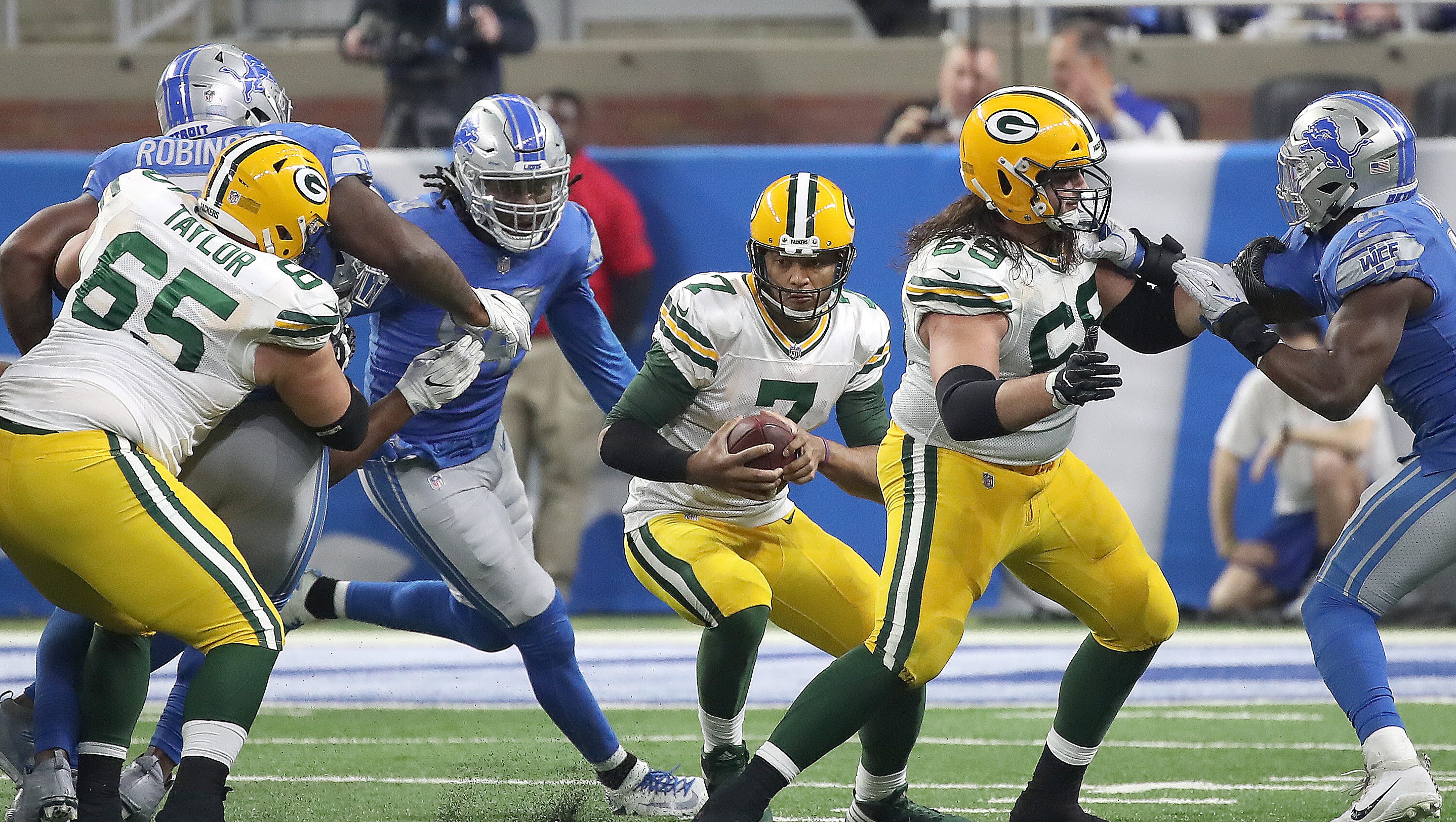 Green Bay Packers quarterback Brett Hundley (7) tries to escape a collapsing pocket as left tackle David Bakhtiari (69) and left guard Lane Taylor (65) block against the Detroit Lions on Dec.  31, 2017, at Ford Field in Detroit.