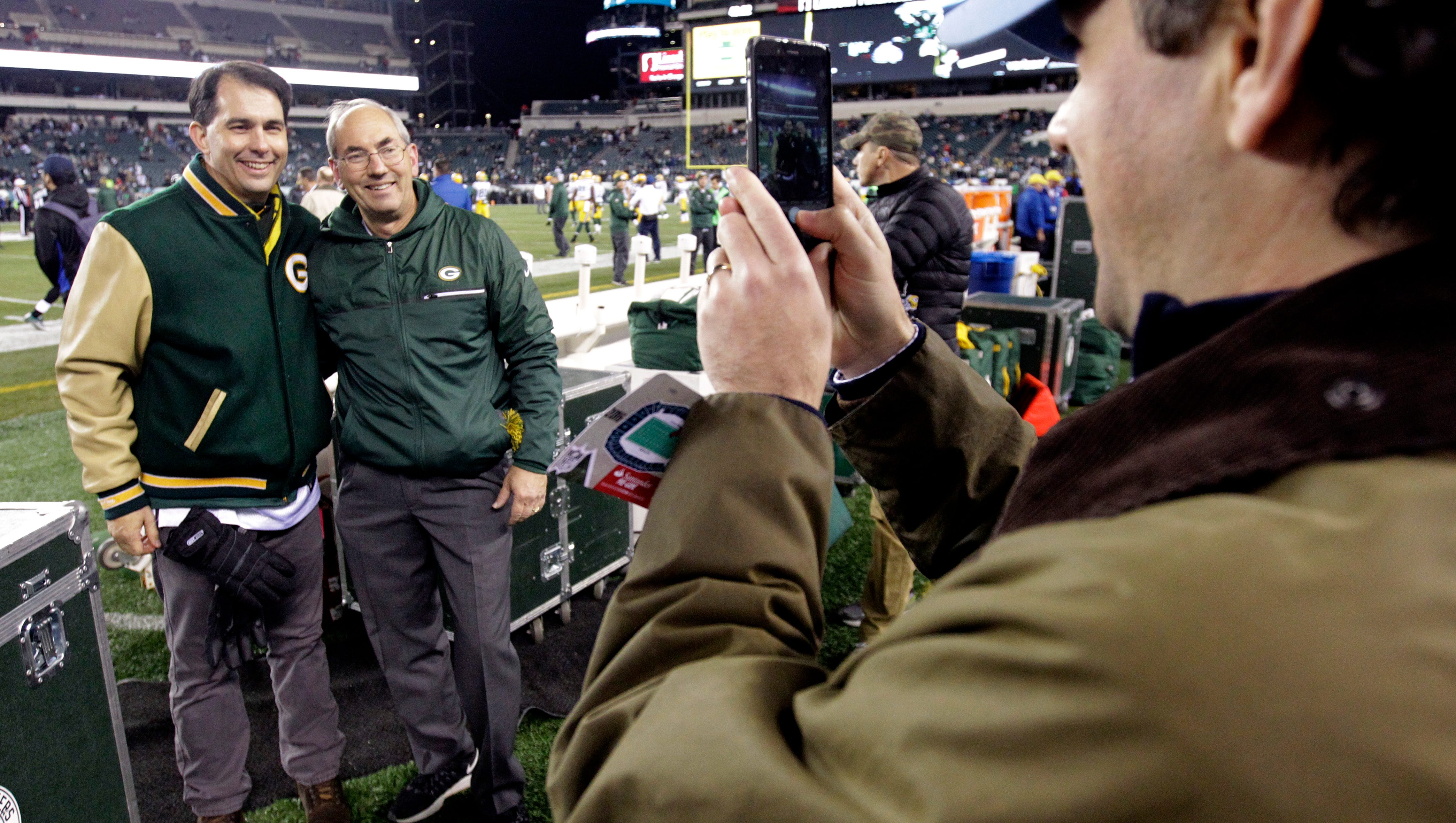 Wisconsin Gov. Scott Walker (left) poses for a photo with Green Bay Packers assistant equipment manager Bryan Nehring before the Packers game against the Philadelphia Eagles.