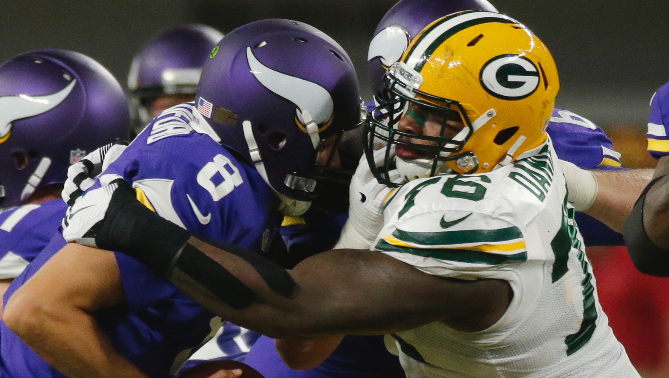 Green Bay Packers defensive end Mike Daniels (76) sacks Minnesota Vikings quarterback Sam Bradford (8) during the first quarter on Sept. 18, 2016, at U.S. Bank Stadium in Minneapolis.