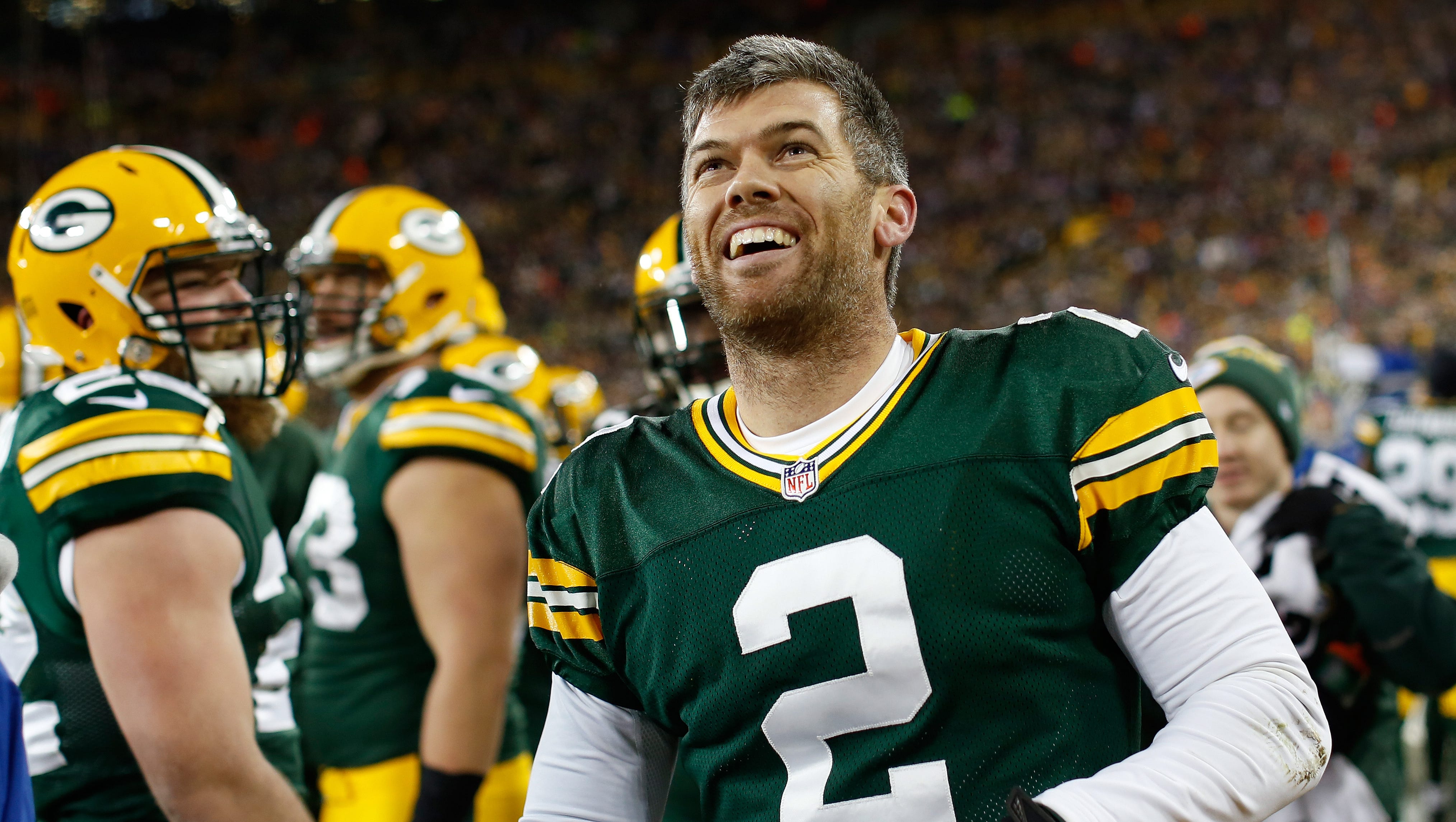 Green Bay Packers kicker Mason Crosby (2) smiles while watching the replay of his forced fumble on Jan. 3, 2016, against the Minnesota Vikings at Lambeau Field.