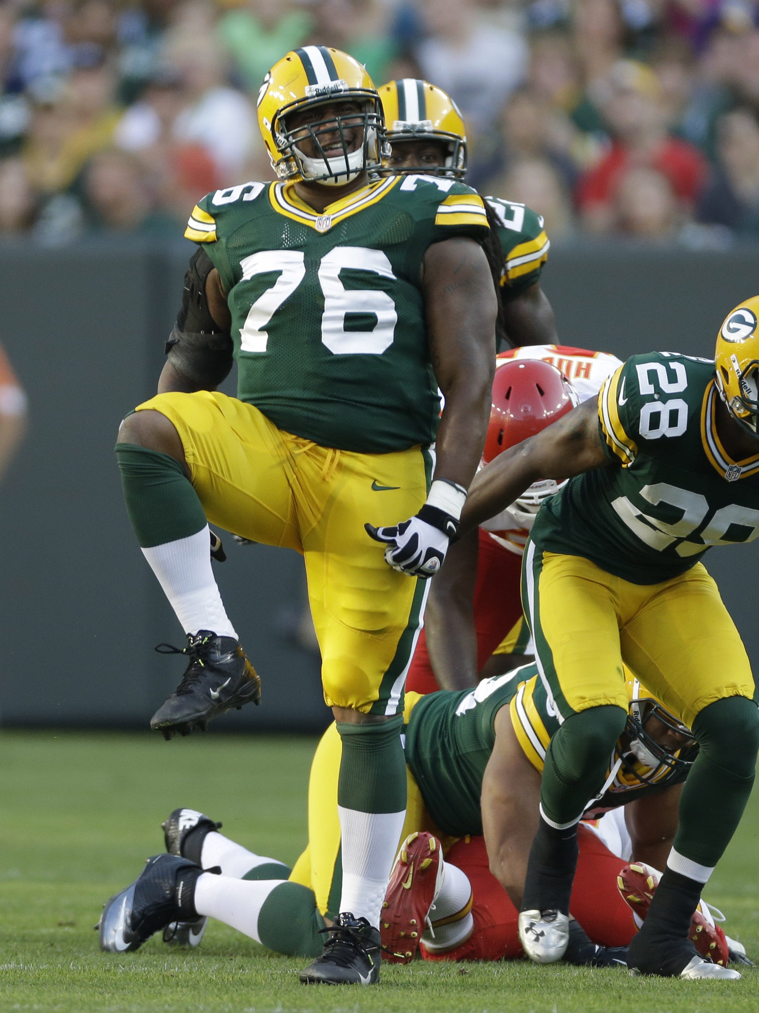 Green Bay Packers defensive end Mike Daniels, left, and  safety Sean Richardson celebrate a defensive play in the first half against the Kansas City Chiefs on Aug. 30, 2012, at Lambeau Field.