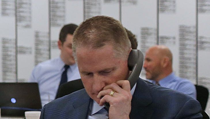 Russ Ball works the phones during the 2016 NFL Draft at Lambeau Field in Green Bay.