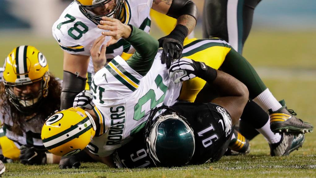 Green Bay Packers quarterback Aaron Rodgers is brought down by Philadelphia Eagles defensive lineman Fletcher Cox. Fletcher was called for roughing the passer on the play at Lincoln Financial Field.