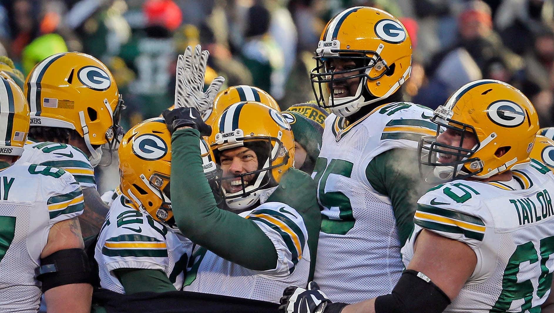 Mason Crosby (2) is surrounded by teammates after hitting a 32-yard field goal with 3 seconds left in the game to give the Green Bay Packers a 30-27 win over the Chicago Bears on Dec. 18, 2016.