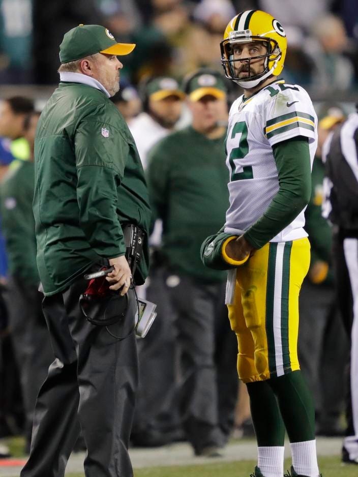 Green Bay Packers quarterback Aaron Rodgers talks with Mike McCarthy in the second quarter against the Philadelphia Eagles at Lincoln Financial Field.
