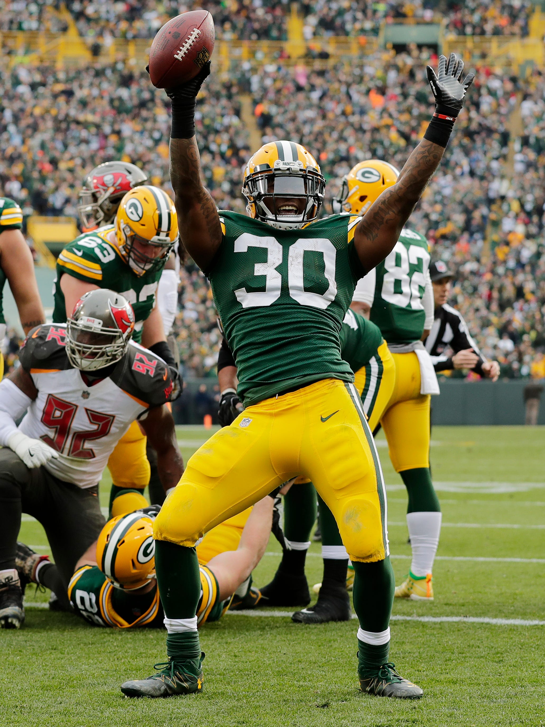 Green Bay Packers running back Jamaal Williams (30) celebrates after scoring a touchdown against the Tampa Bay Buccaneers in the second quarter at Lambeau Field on Sunday, December 3, 2017 in Green Bay, Wis.