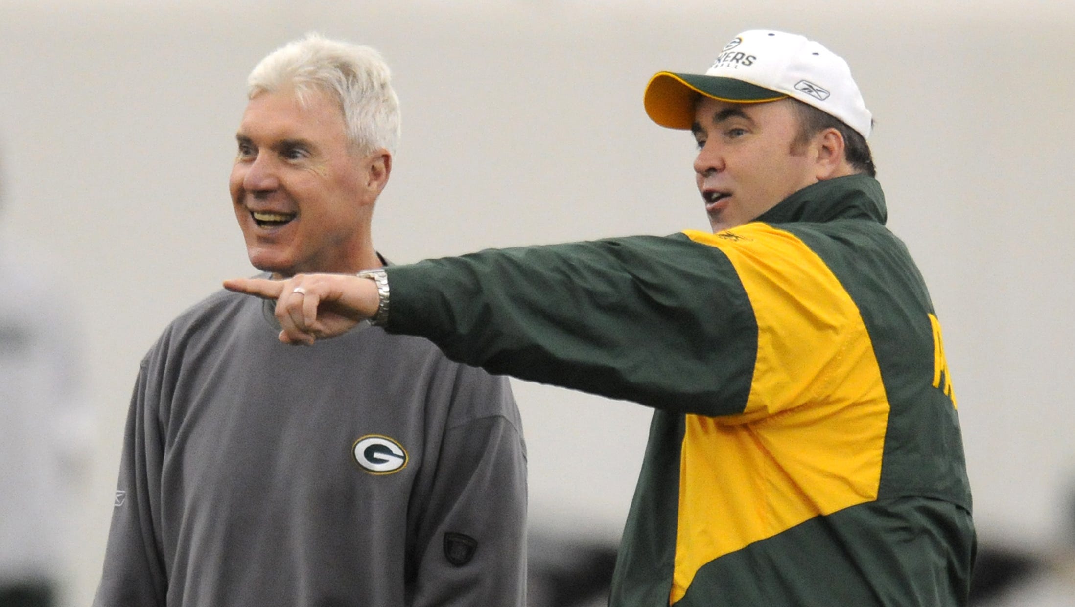 Green Bay Packers general manager Ted Thompson, left, shares a laugh with coach Mike McCarthy during OTAs practice on June 12, 2008, in the Don Hutson Center.