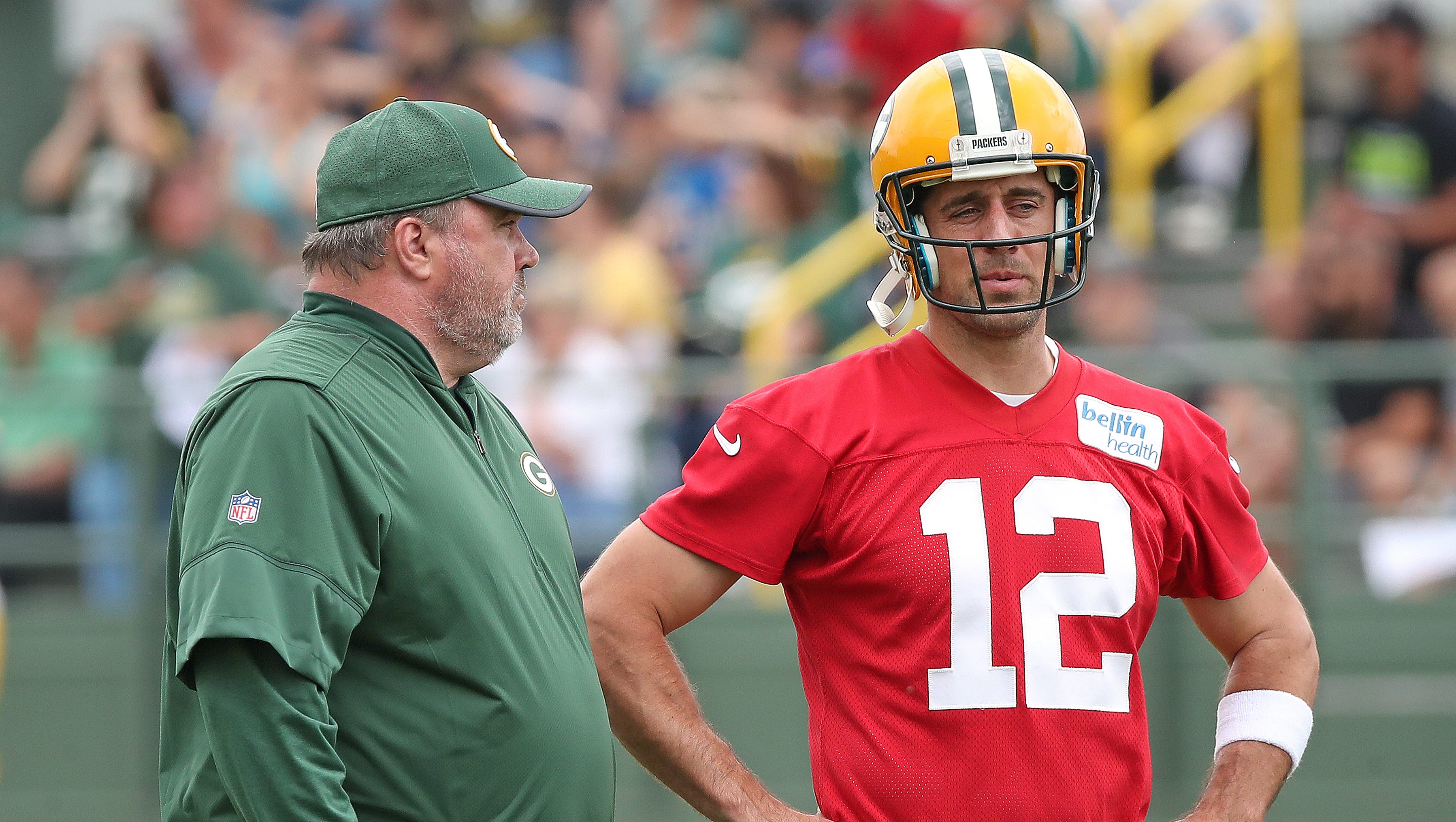 Green Bay Packers quarterback Aaron Rodgers (12) talks with coach Mike McCarthy during OTAs practice on May 31, 2018, at Ray Nitschke Field.