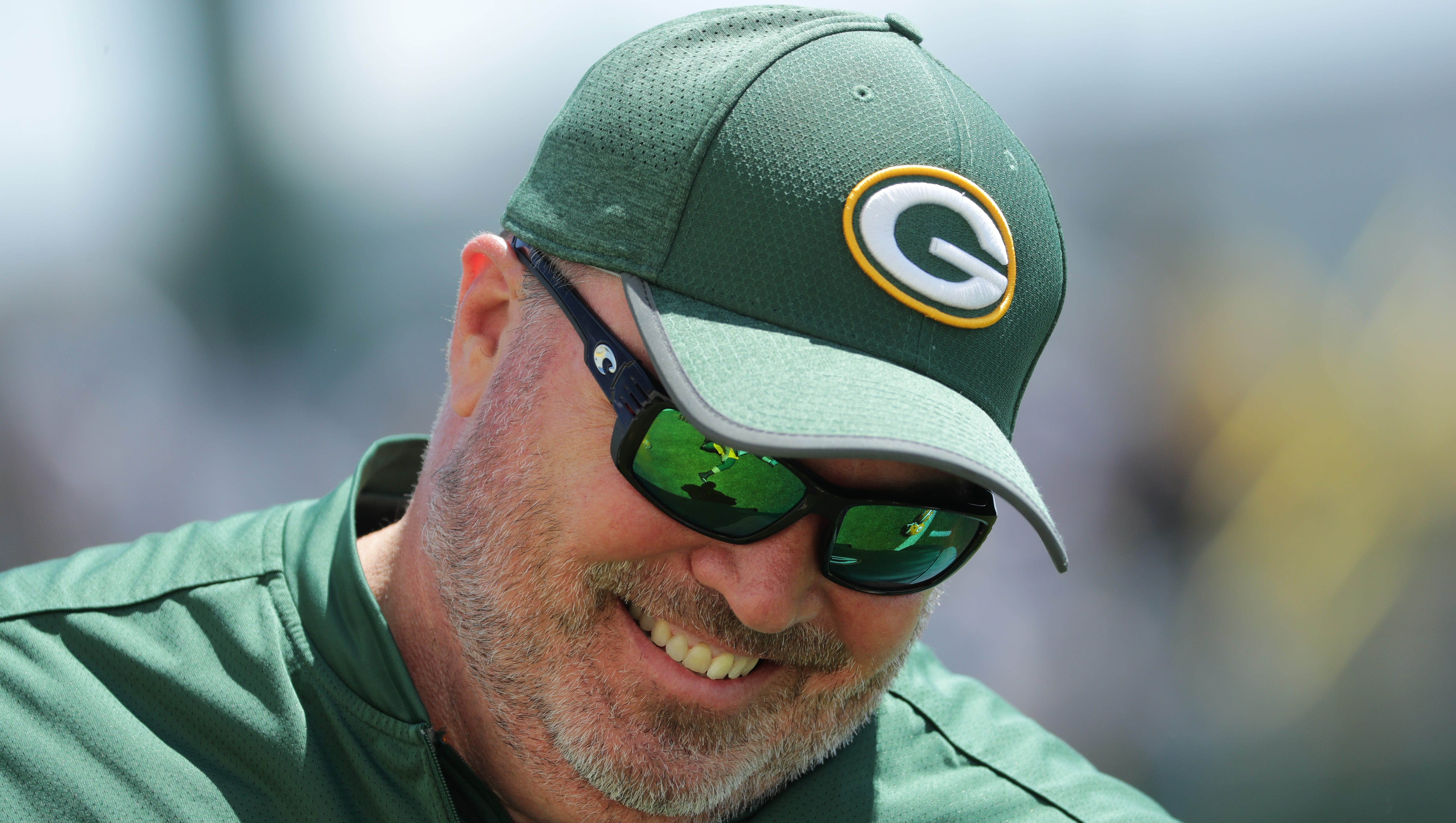 Green Bay Packers coach Mike McCarthy smiles during organized team activities on June 4, 2018 in Green Bay.