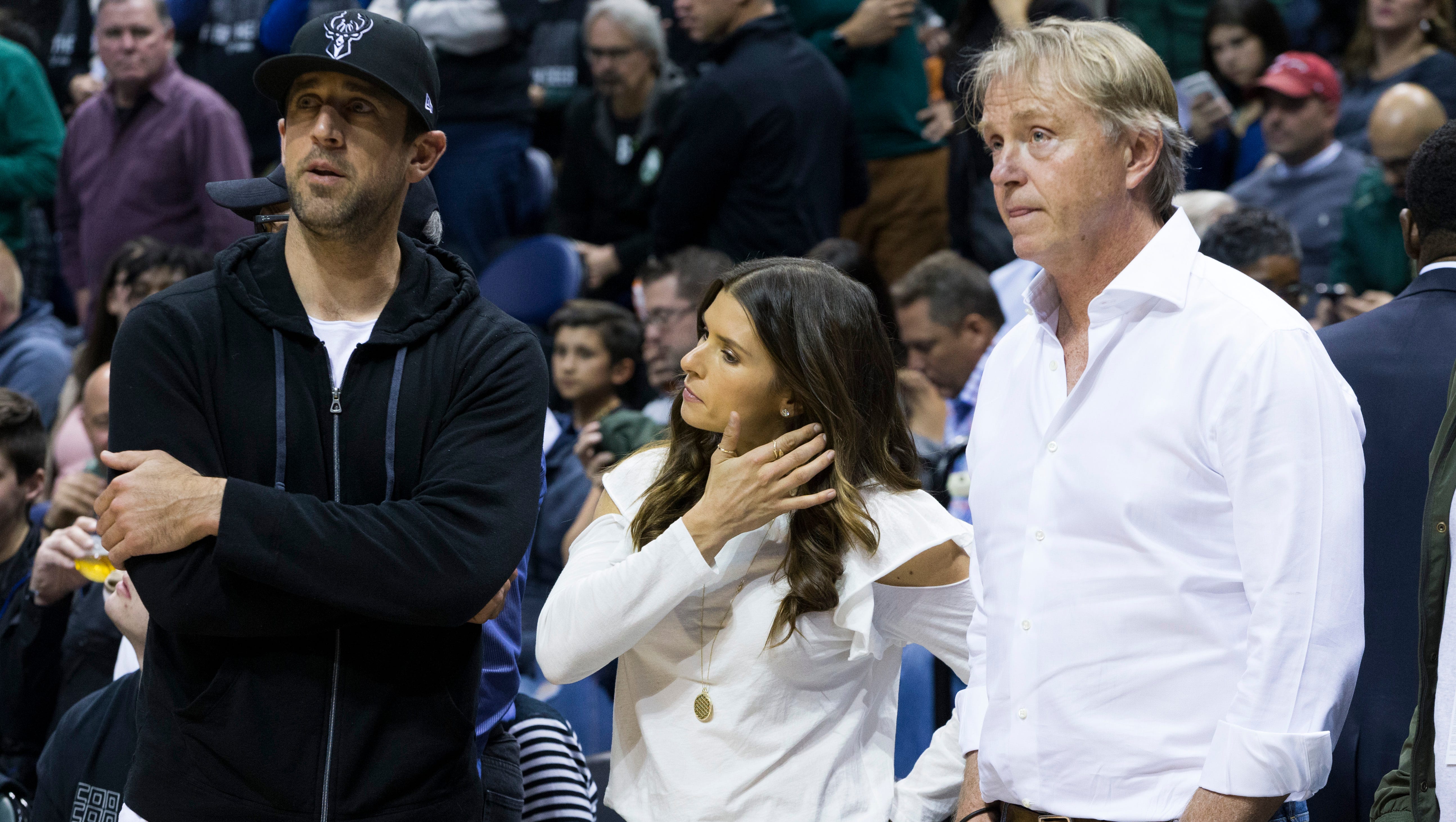 Green Bay Packers quarterback Aaron Rodgers (left) and Danica Patrick, his race car driver girlfriend, look on with Wes Edens, one of the Milwaukee Bucks' owners at the BMO Harris Bradley Center on Friday night.