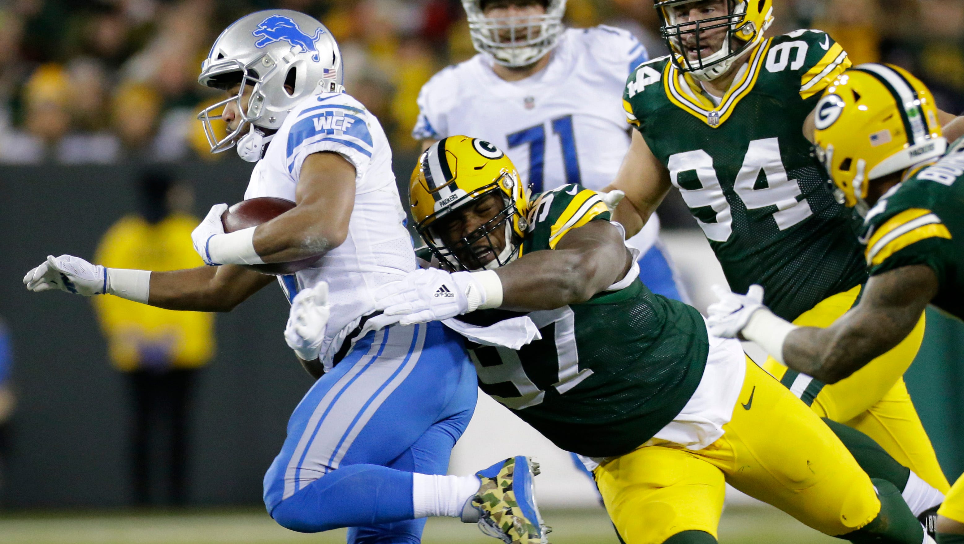 Detroit Lions' Golden Tate (15) is stopped short of  first down by Green Bay Packers nose tackle Kenny Clark (97) during the second quarter of their game Monday, November 6, 2017 at Lambeau Field in Green Bay, Wis.
